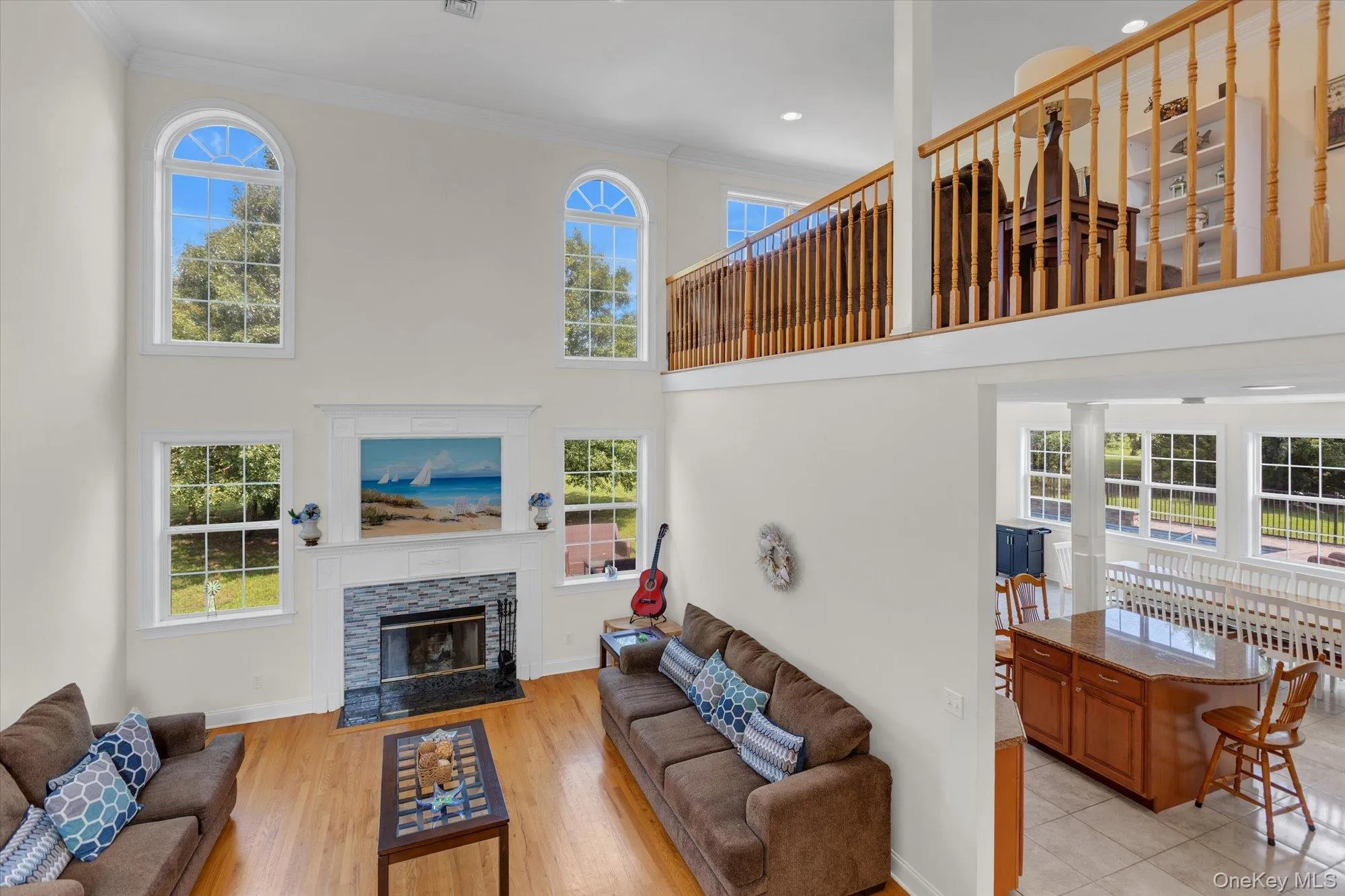 Two-story living room with soaring ceilings, arched transom windows, and abundant natural light Two-story living room with soaring ceilings, arched transom windows, and abundant natural light