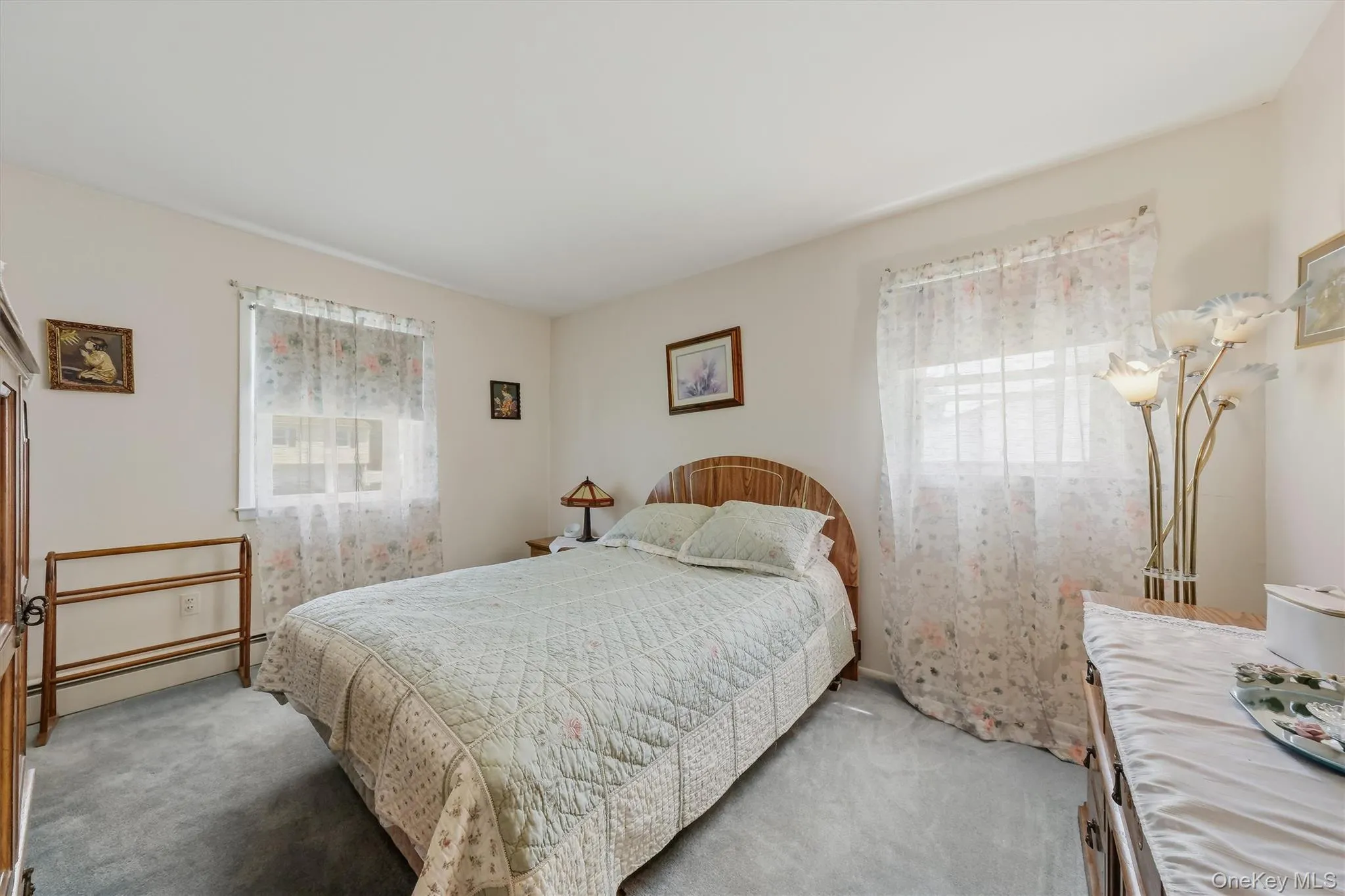 Generous sized primary with hardwood flooring underneath carpeting Generous sized primary with hardwood flooring underneath carpeting