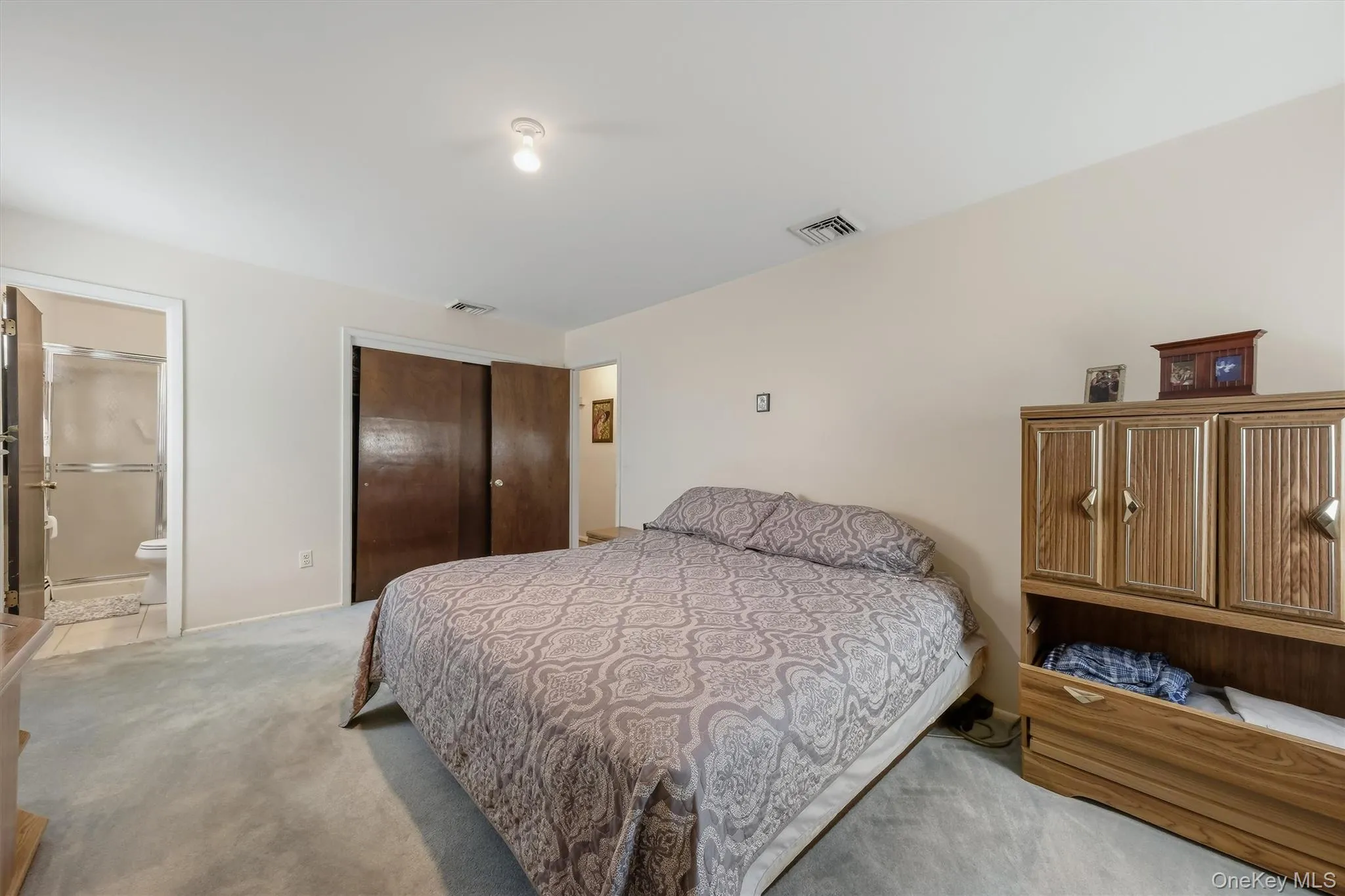 Generous sized primary with hardwood flooring underneath carpeting Generous sized primary with hardwood flooring underneath carpeting