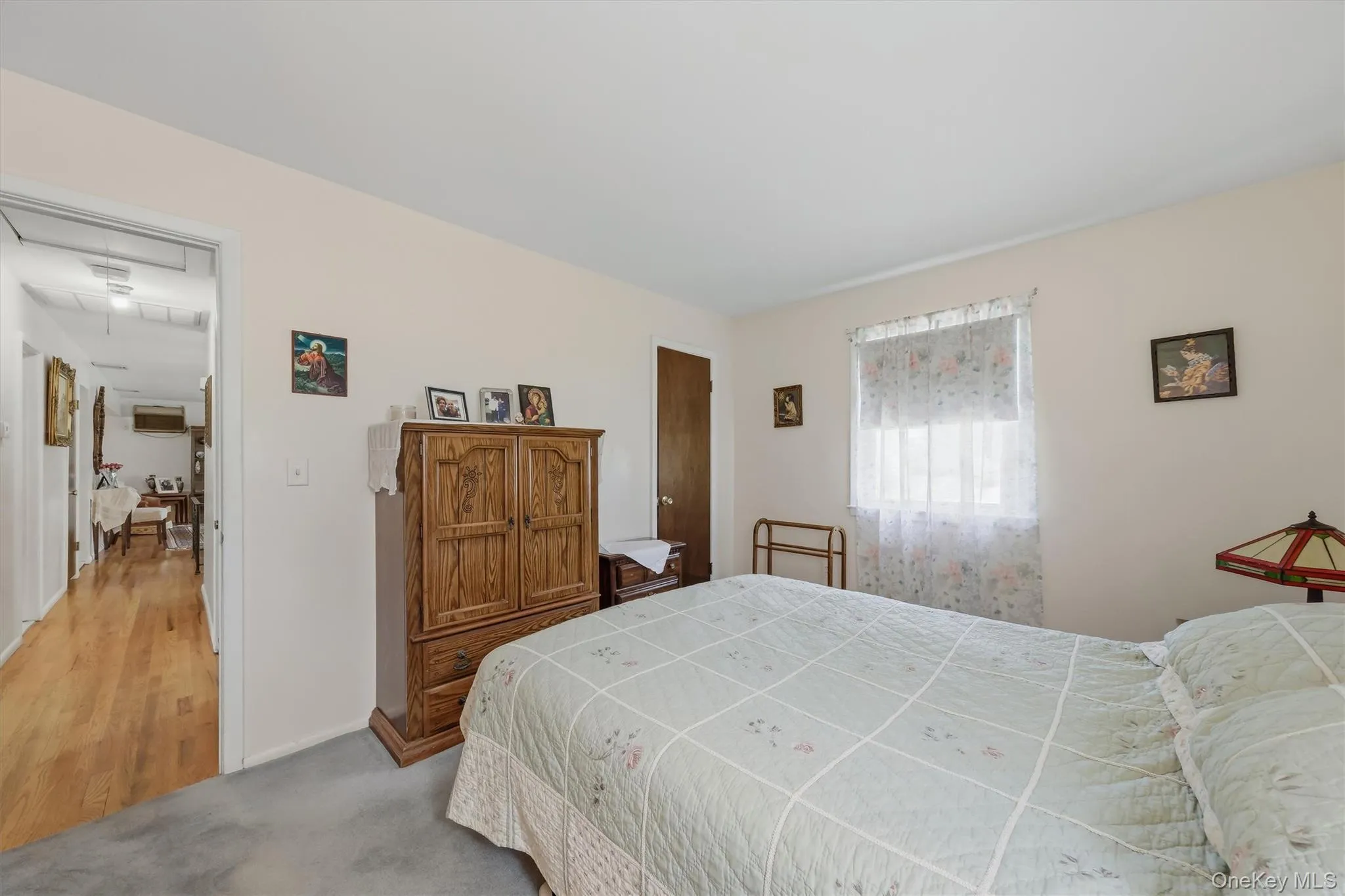 Generous sized primary with hardwood flooring underneath carpeting Generous sized primary with hardwood flooring underneath carpeting
