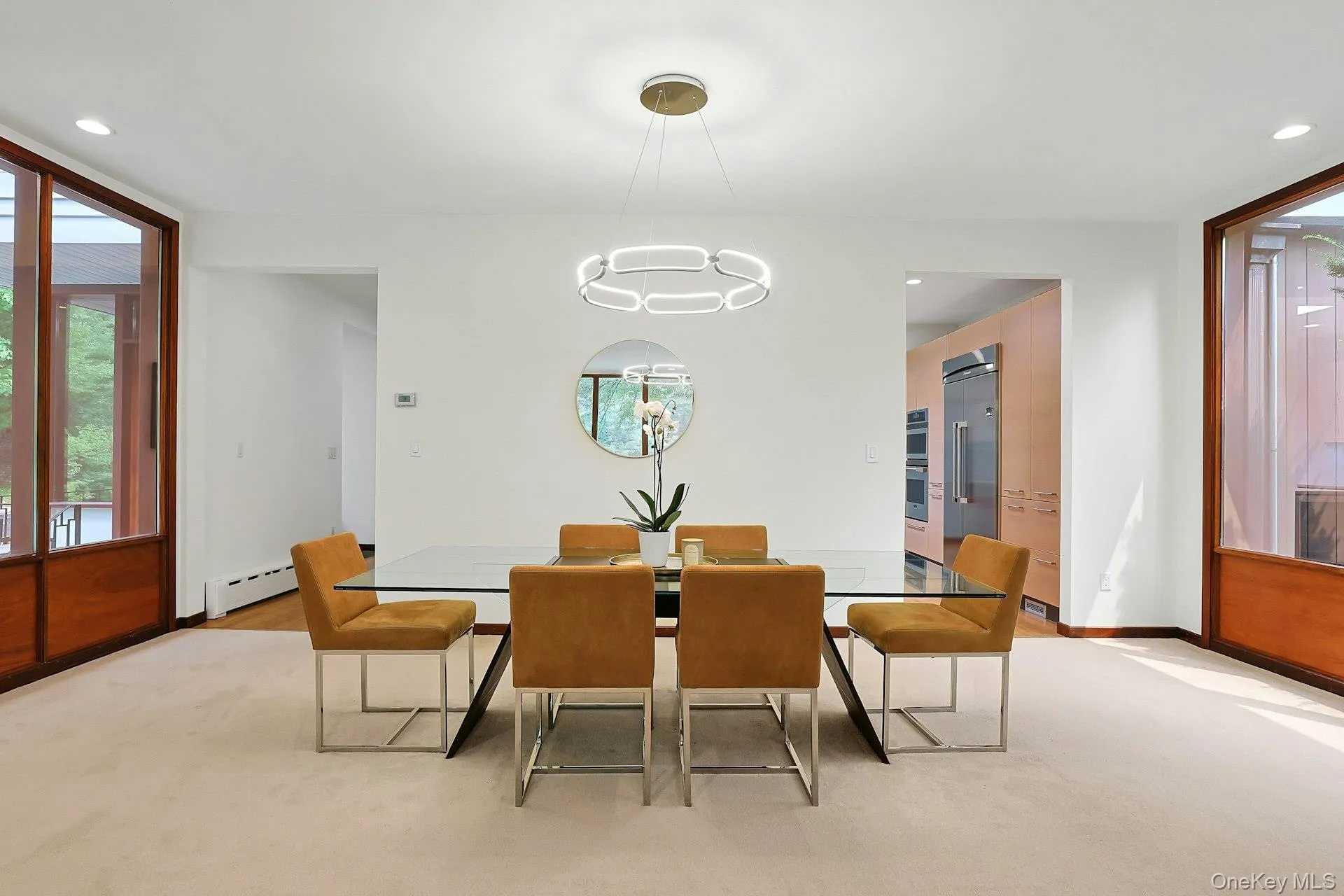 The spacious dining area is perfectly positioned between the dramatic living room and the beautifully renovated kitchen, creating an ideal setting for both intimate dinners and larger gatherings while maintaining the home's signature open-concept design. The spacious dining area is perfectly positioned between the dramatic living room and the beautifully renovated kitchen, creating an ideal setting for both intimate dinners and larger gatherings while maintaining the home's signature open-concept design.