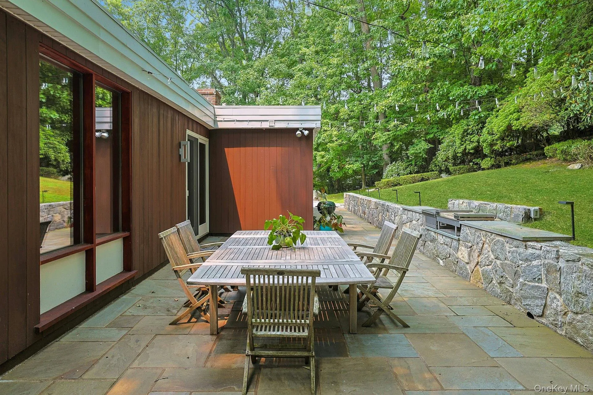 Sliding doors from the breakfast room create a seamless connection between indoor living and this beautifully designed outdoor entertaining space. Sliding doors from the breakfast room create a seamless connection between indoor living and this beautifully designed outdoor entertaining space.