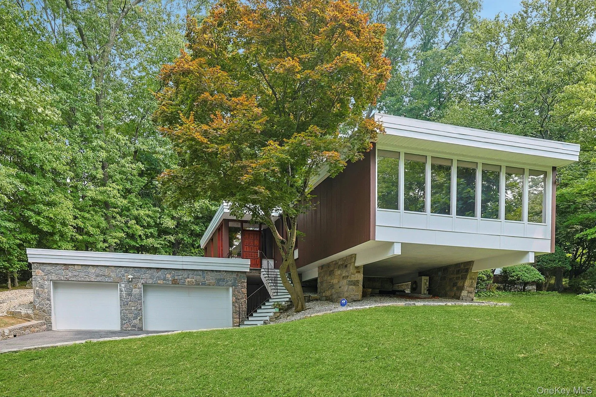 Distinctive contemporary architecture is beautifully complemented by natural stone accents, expansive windows, and a private, park-like setting. Distinctive contemporary architecture is beautifully complemented by natural stone accents, expansive windows, and a private, park-like setting.