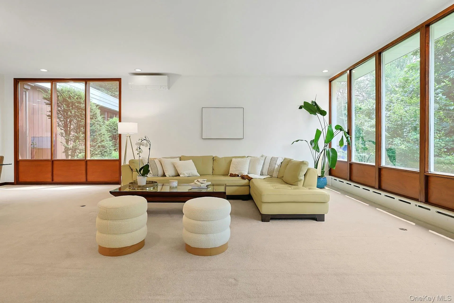 A warm and inviting gathering space with iconic Mid-Century Modern styling, offering panoramic wooded views and an effortless flow for everyday living and entertaining. A warm and inviting gathering space with iconic Mid-Century Modern styling, offering panoramic wooded views and an effortless flow for everyday living and entertaining.