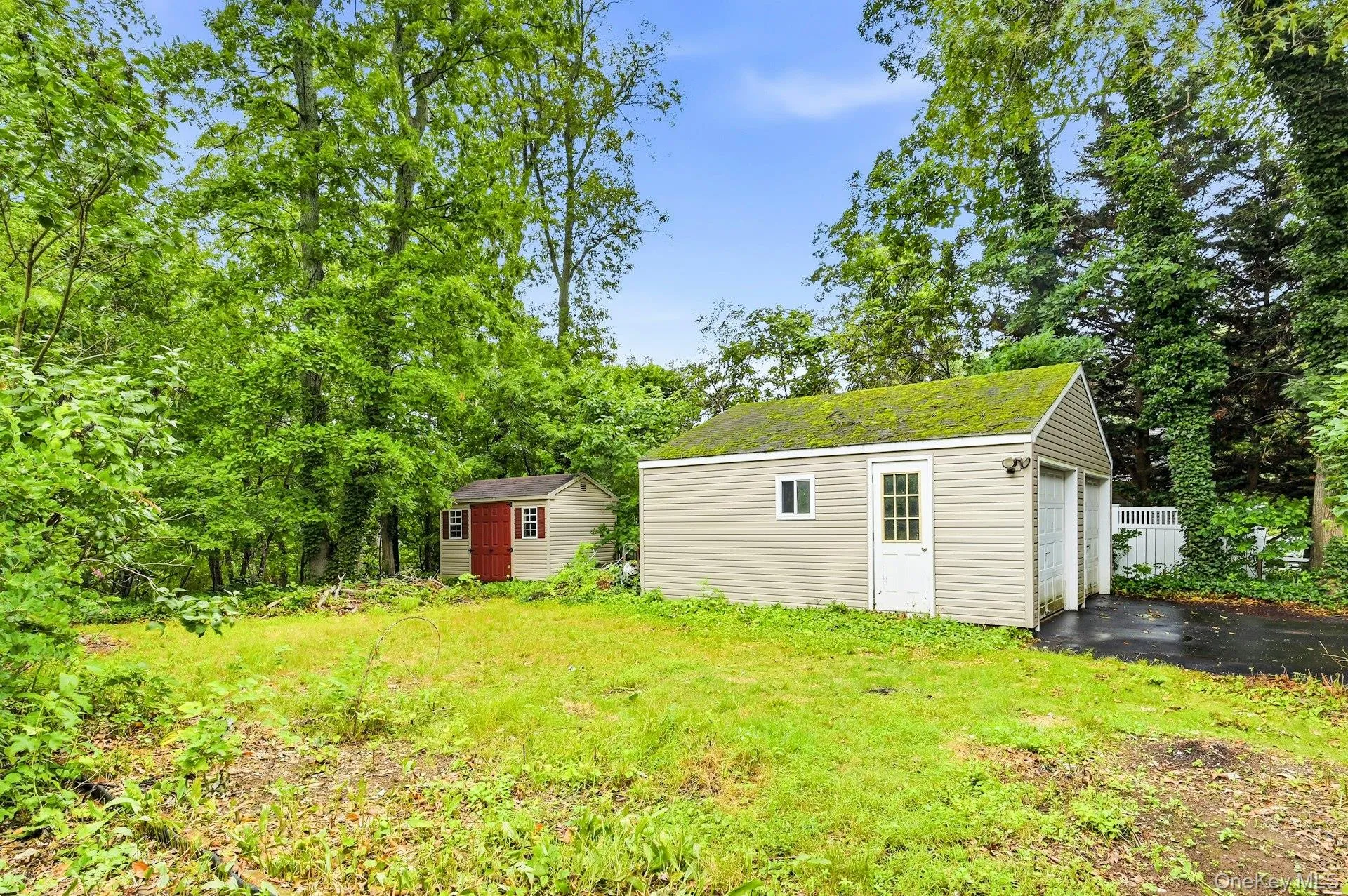 Back yard with side of detached 2 car garage and shed. Back yard with side of detached 2 car garage and shed.