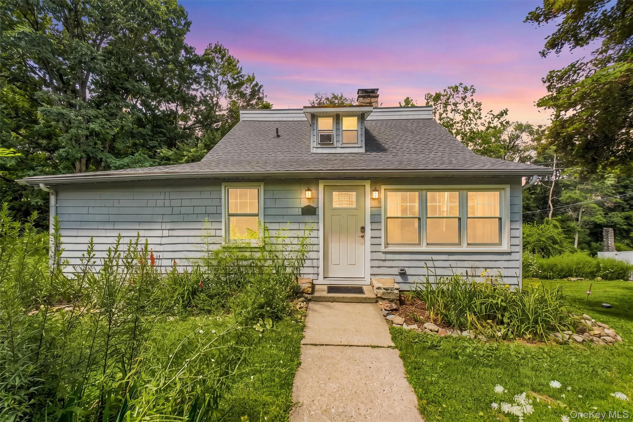 Updated Cap Cod with deeds lake rights to Oscawana Lake. Light blue horizontal siding facade with white trim Updated Cap Cod with deeds lake rights to Oscawana Lake. Light blue horizontal siding facade with white trim
