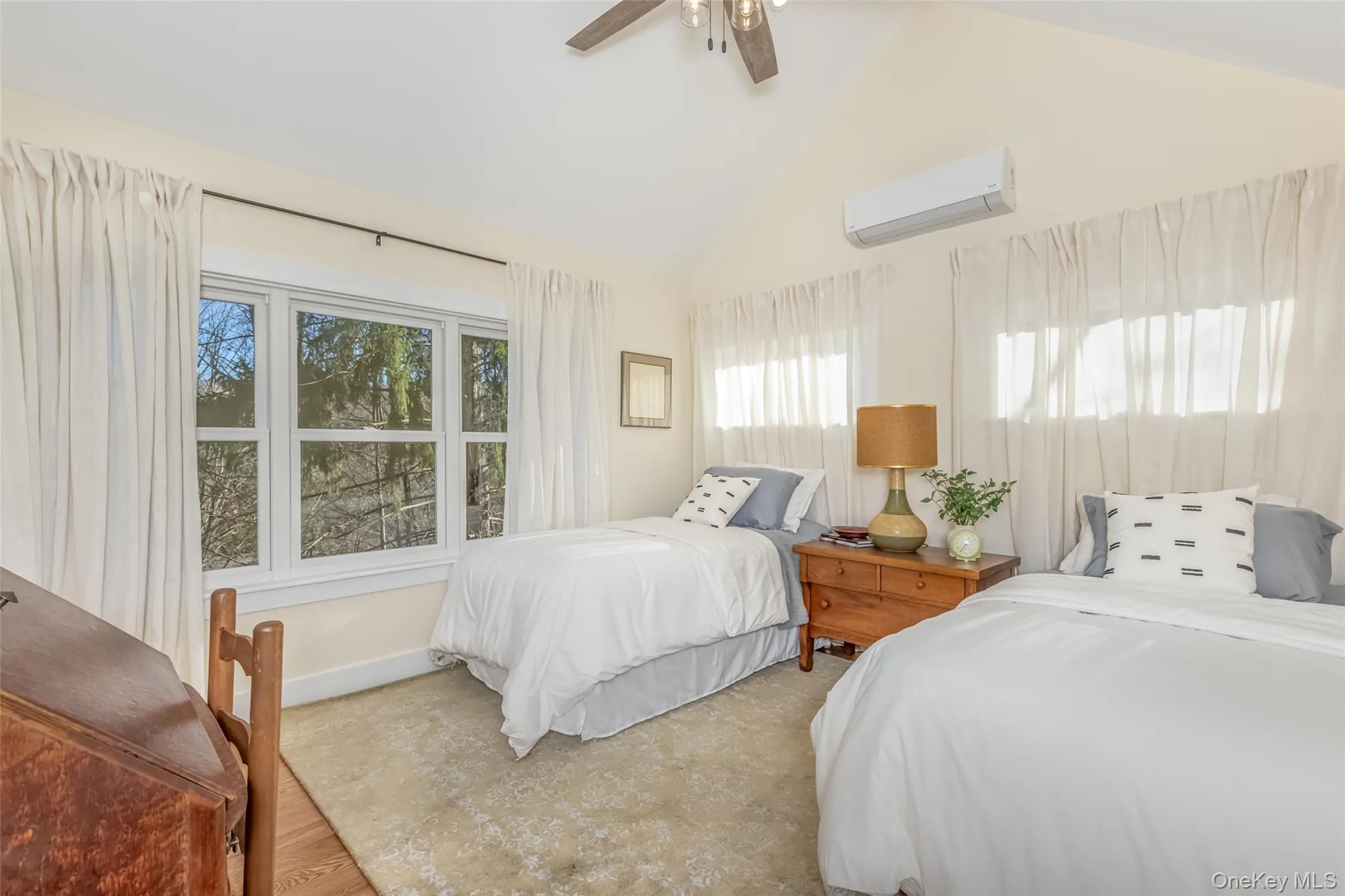 Bedroom with ceiling fan, an AC wall unit, and high vaulted ceiling Bedroom with ceiling fan, an AC wall unit, and high vaulted ceiling