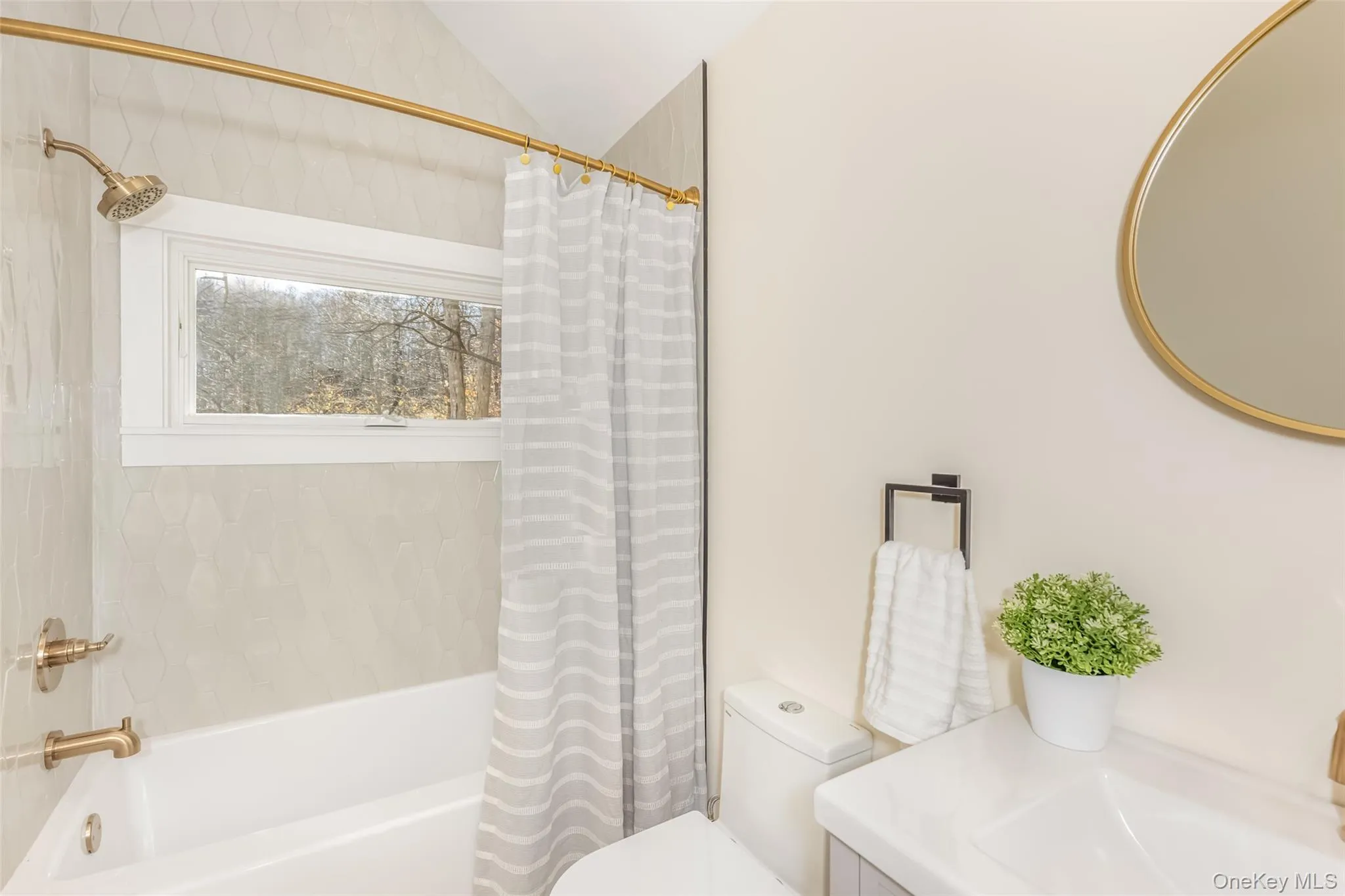 Bathroom featuring toilet, shower / bath combo, and vaulted ceiling Bathroom featuring toilet, shower / bath combo, and vaulted ceiling
