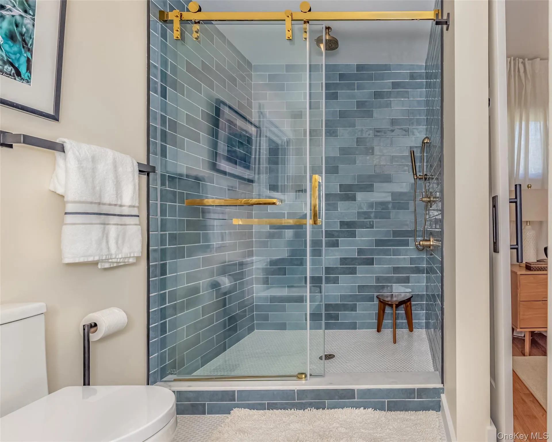 Bathroom featuring hardwood / wood-style flooring, an enclosed shower, and toilet Bathroom featuring hardwood / wood-style flooring, an enclosed shower, and toilet