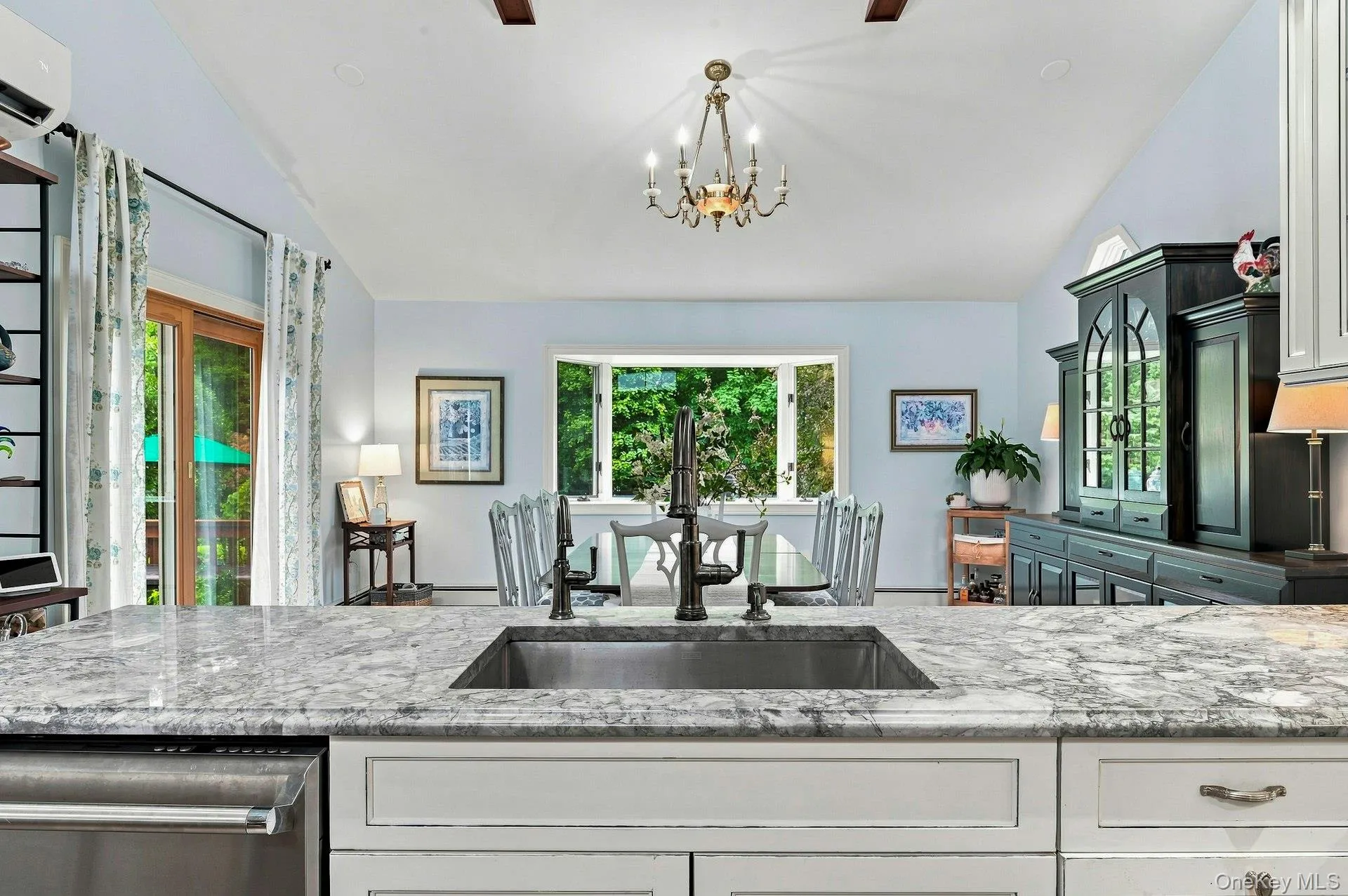 Granite counter tops on island overlooking spacious dining area Granite counter tops on island overlooking spacious dining area