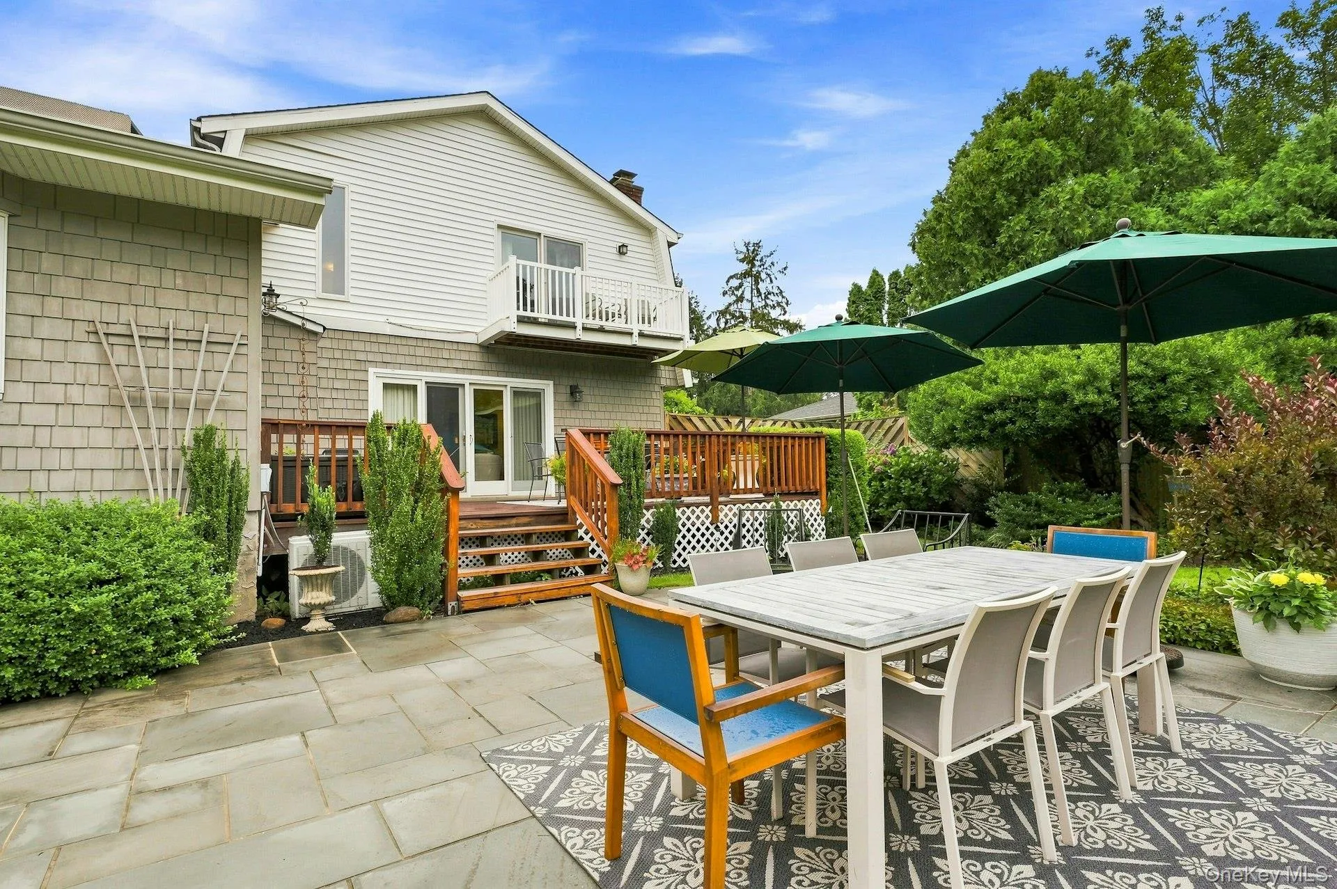 block patio, looking at redwood deck and back of home and balcony off block patio, looking at redwood deck and back of home and balcony off