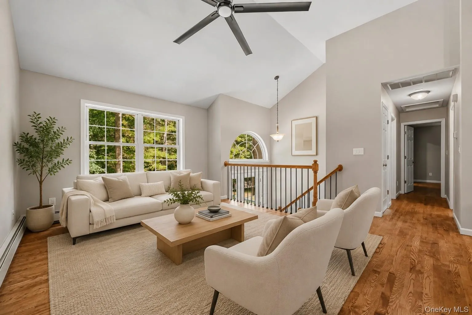 Living room with hardwood floors. Staged with furniture. Living room with hardwood floors. Staged with furniture.