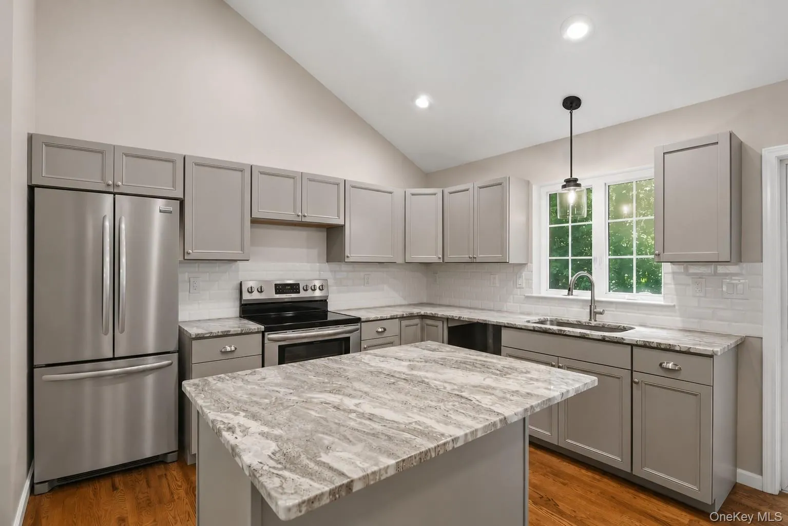 Kitchen with hardwood floors and stainless Frigidaire appliances. Kitchen with hardwood floors and stainless Frigidaire appliances.