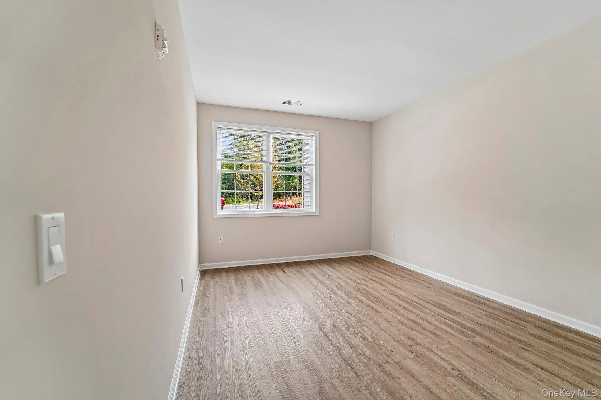 Neutral-toned interior featuring wood-finish flooring and a white trim package Neutral-toned interior featuring wood-finish flooring and a white trim package