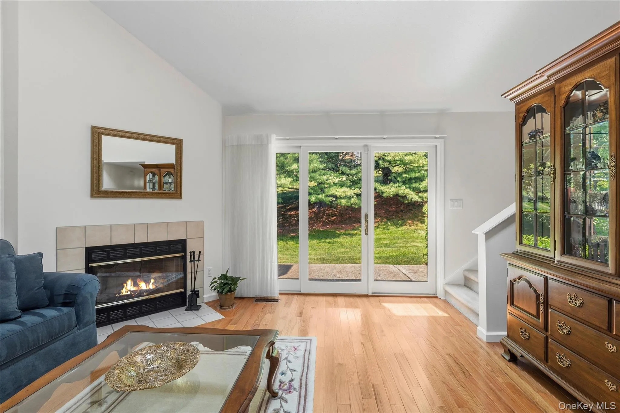 Living room with hardwood floors & slider to private patio. Living room with hardwood floors & slider to private patio.