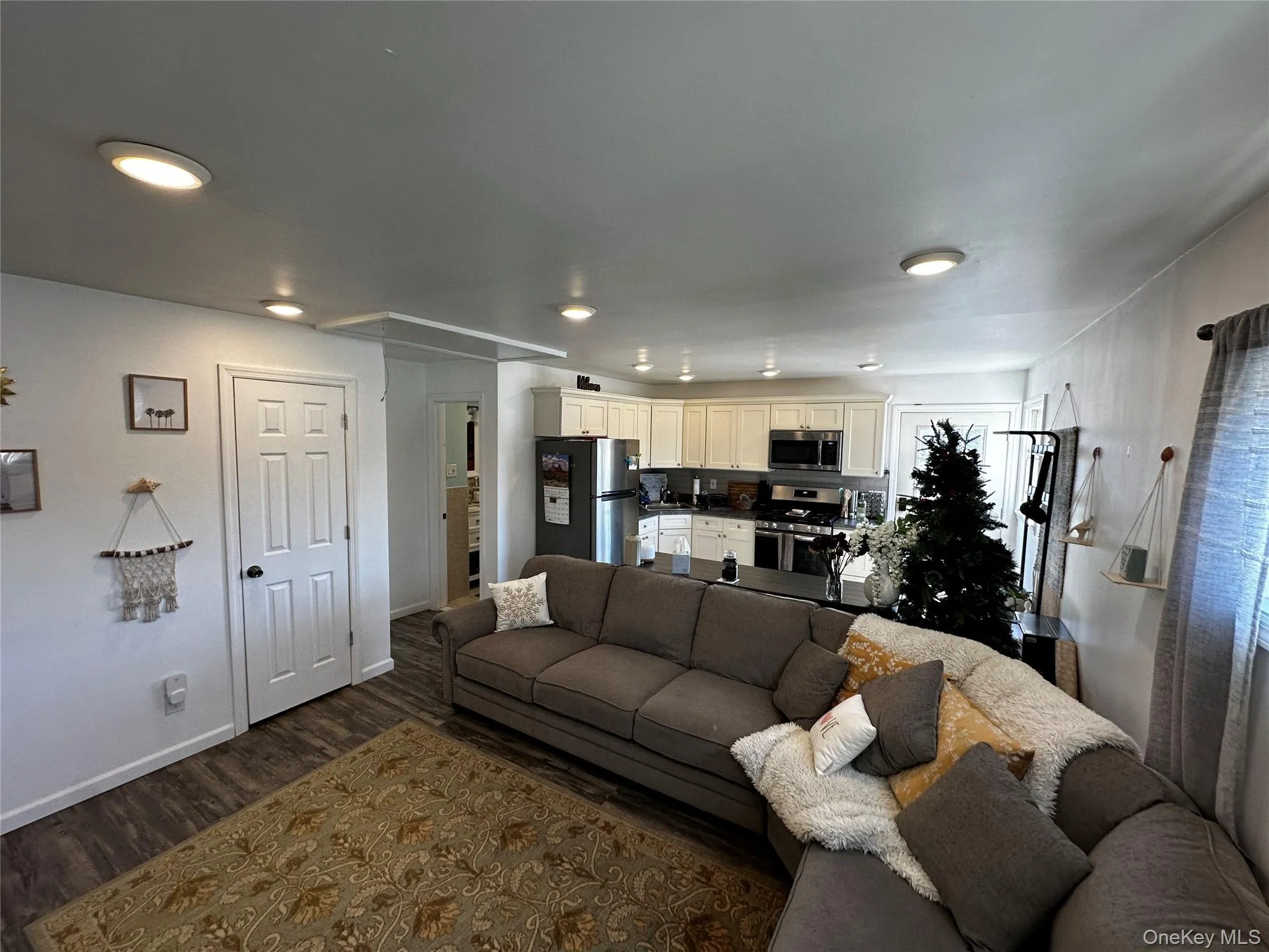 Open-concept living area featuring wood-finish flooring Open-concept living area featuring wood-finish flooring