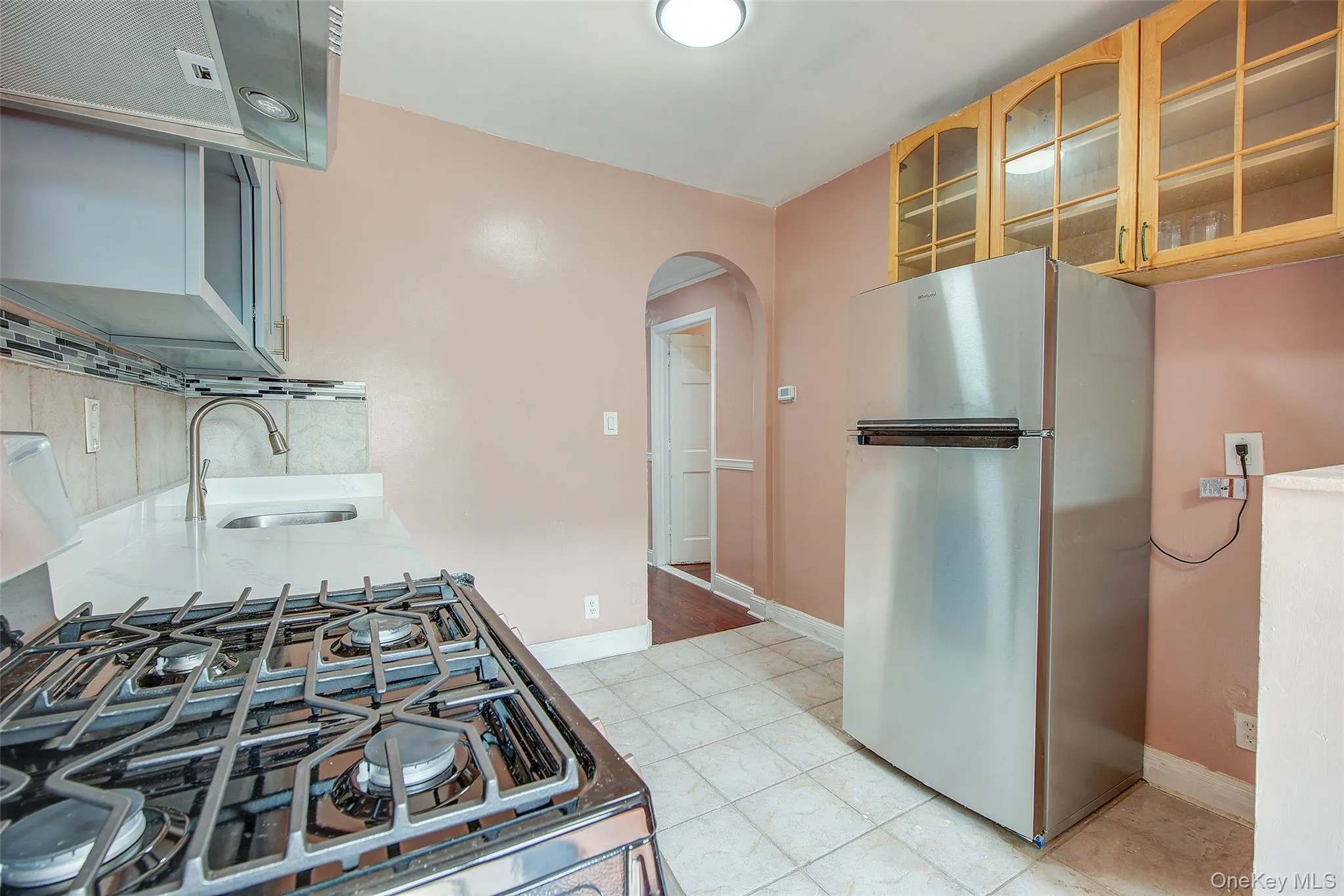 whirlpool fridge and extra storage, kitchen leads to hallway whirlpool fridge and extra storage, kitchen leads to hallway