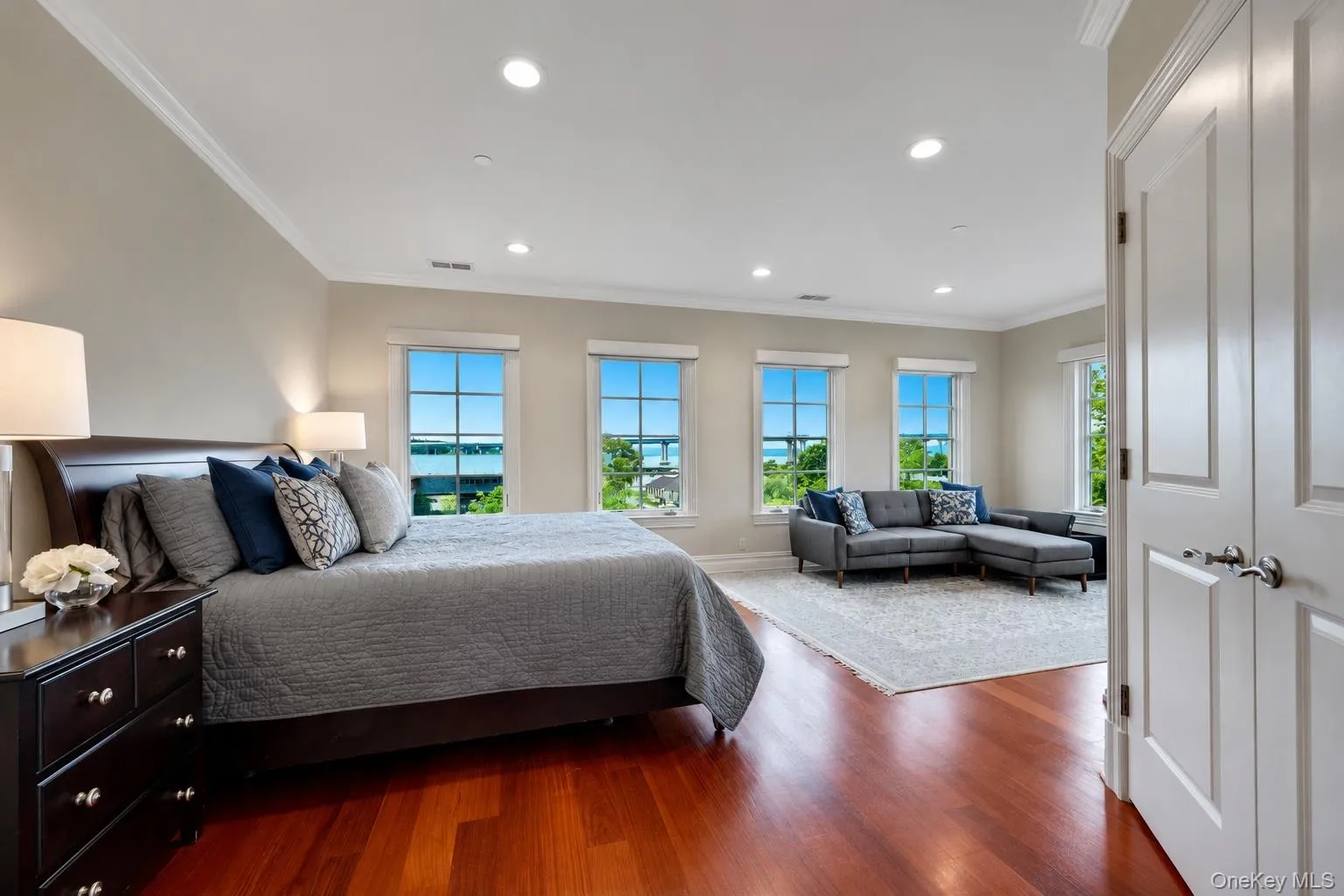 Sprawling primary en suite with river views & automatic Hunter Douglas blinds. Sprawling primary en suite with river views & automatic Hunter Douglas blinds.