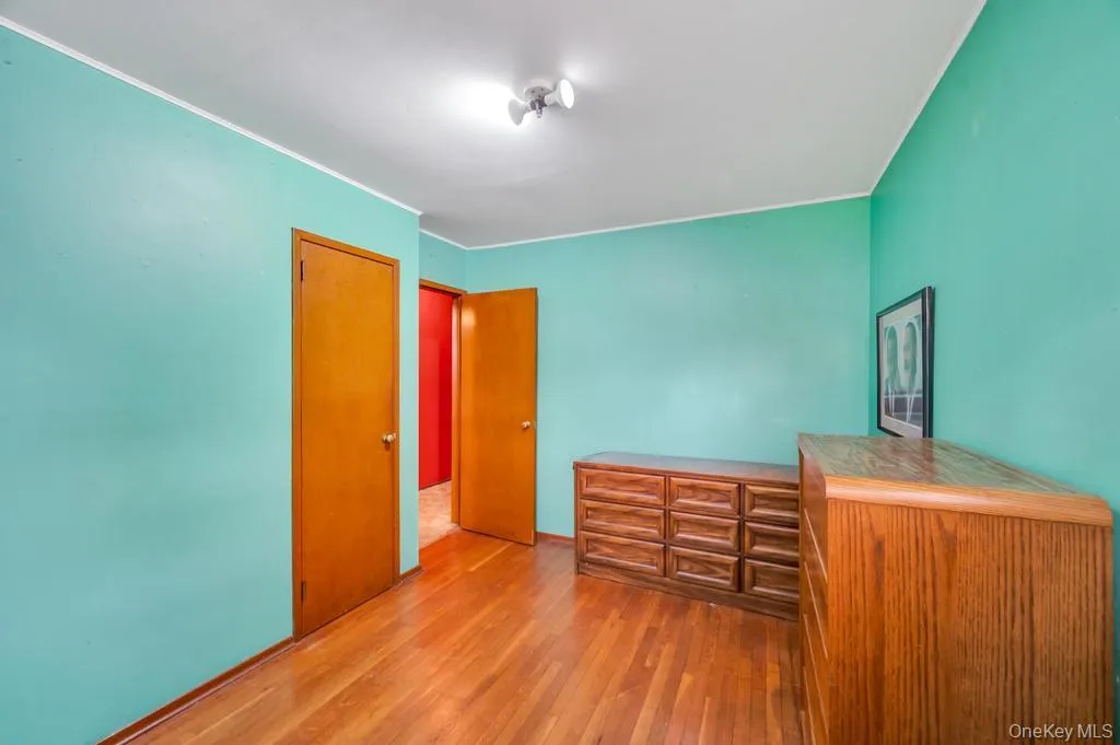 Hardwood flooring throughout featuring light wood-finish doors, track lighting, and white trim Hardwood flooring throughout featuring light wood-finish doors, track lighting, and white trim