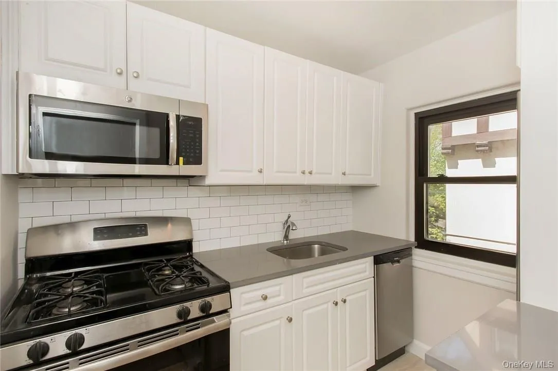 Kitchen with Quartz Counters & Stainless Steel Appliances and storage Pantry Kitchen with Quartz Counters & Stainless Steel Appliances and storage Pantry