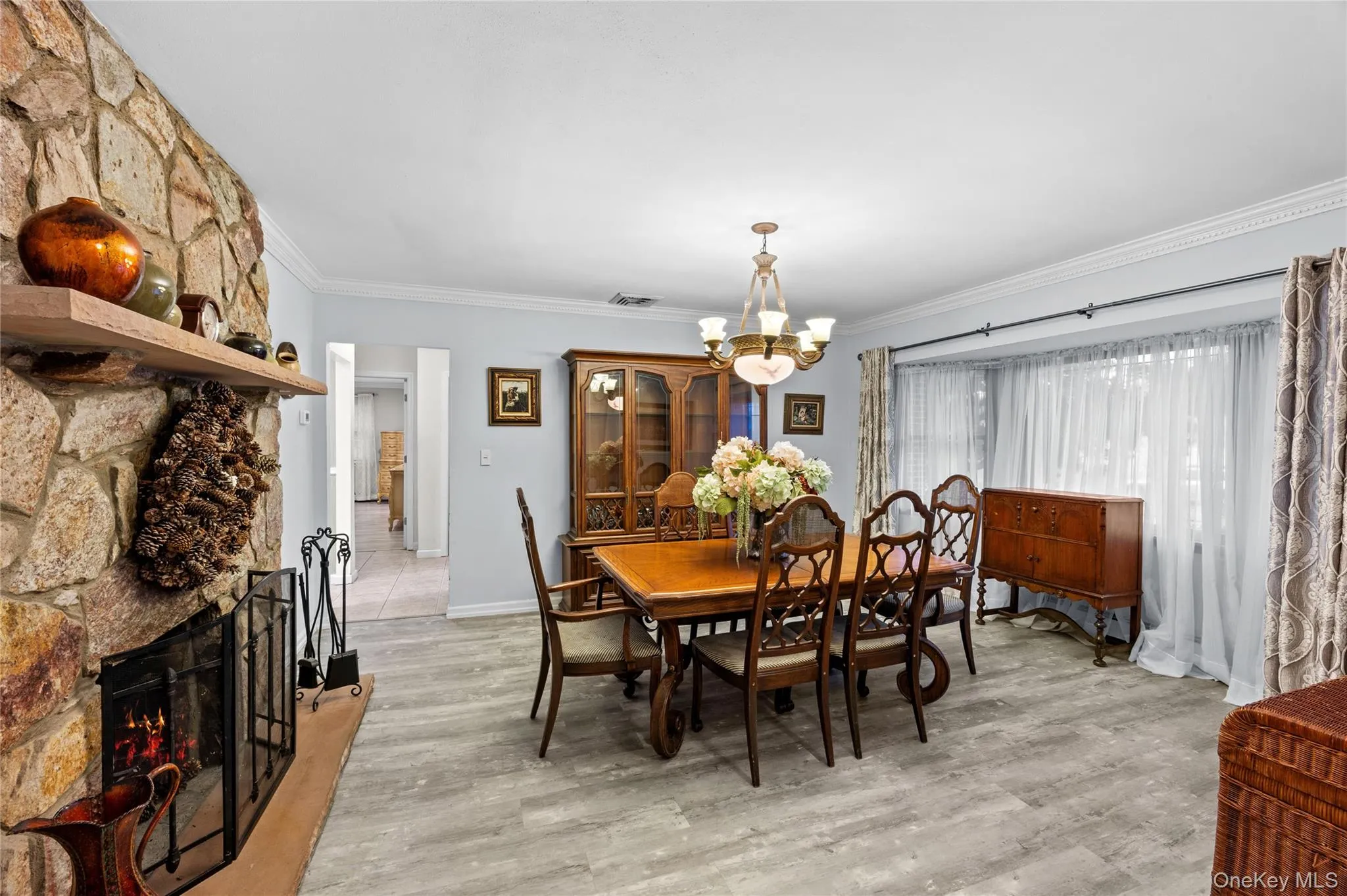 Stone-clad fireplace featuring a wood mantel Stone-clad fireplace featuring a wood mantel
