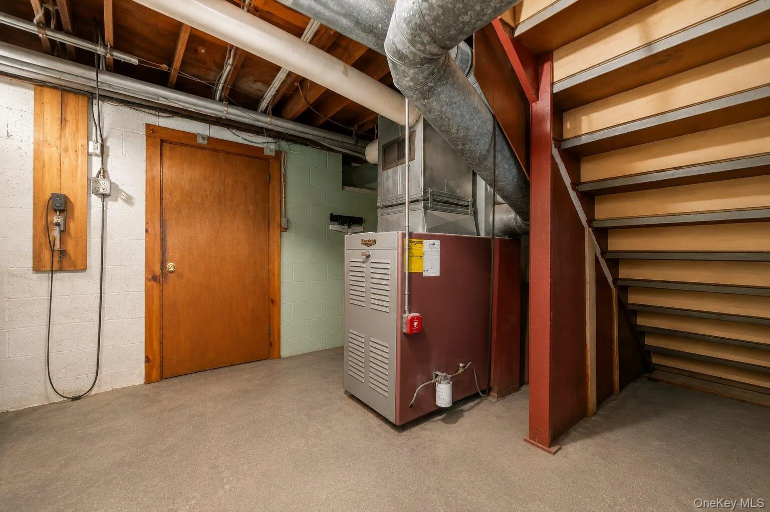 Clean and accessible lower-level mechanical area featuring the home’s heating system, exposed utility connections, storage potential, and staircase access. Clean and accessible lower-level mechanical area featuring the home’s heating system, exposed utility connections, storage potential, and staircase access.