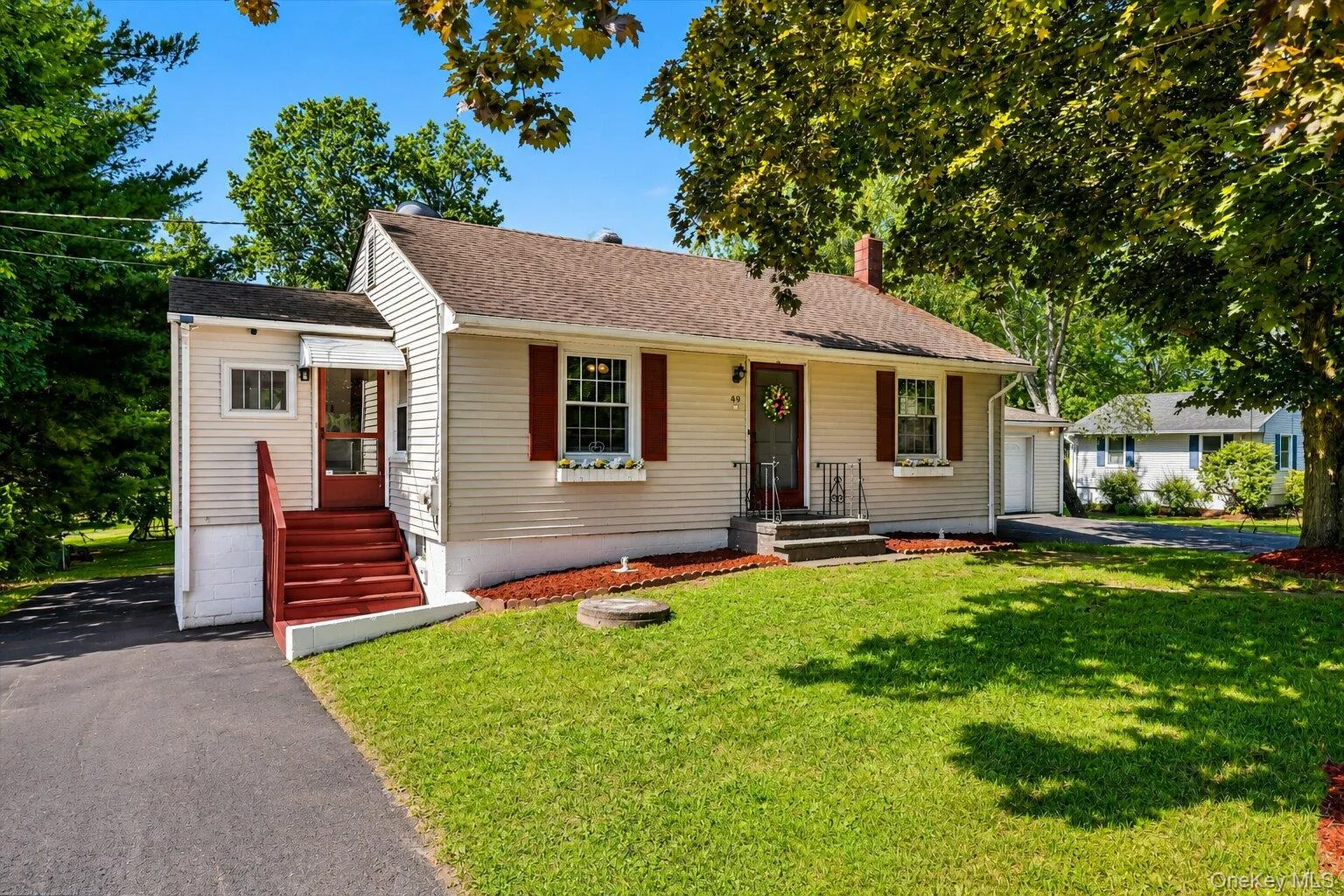 Welcoming front view of this charming home with mature shade trees, landscaped flower beds, and a paved driveway. Welcoming front view of this charming home with mature shade trees, landscaped flower beds, and a paved driveway.