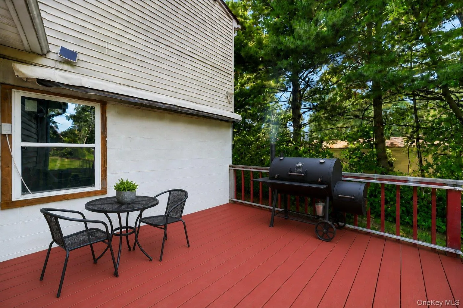 Virtually Staged. Spacious deck with room for grilling and outdoor dining, surrounded by mature trees for added shade and privacy. Virtually Staged. Spacious deck with room for grilling and outdoor dining, surrounded by mature trees for added shade and privacy.