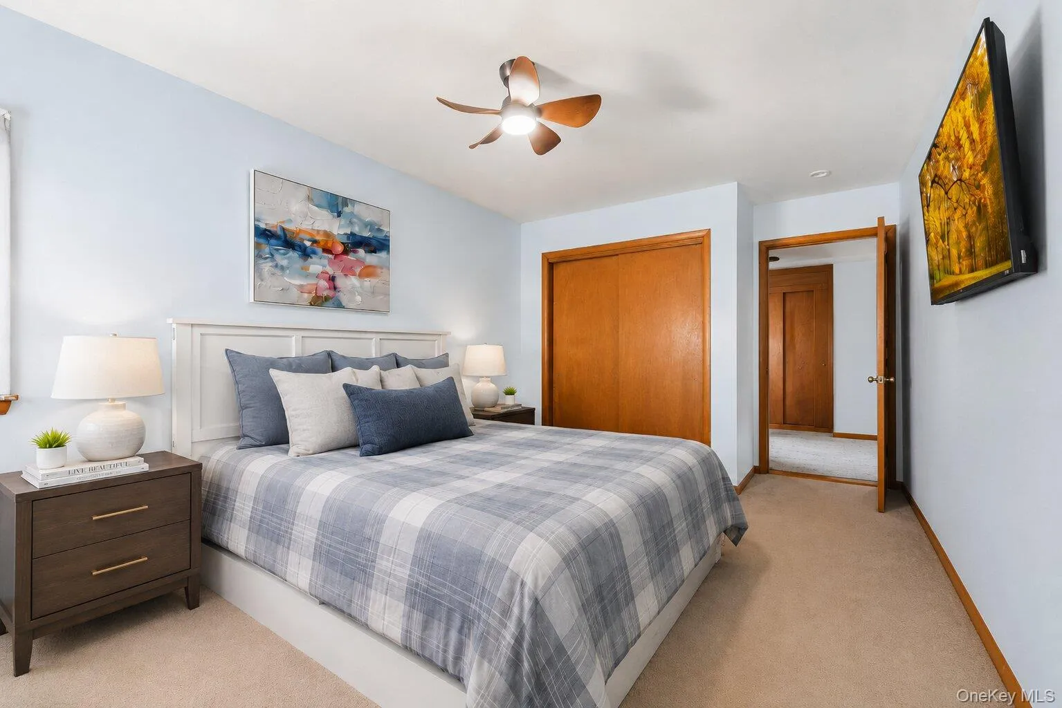 Virtually Staged Primary Bedroom: Comfortable primary bedroom with soft carpeting, generous closet space, a ceiling fan, and room for a complete bedroom set. Virtually Staged Primary Bedroom: Comfortable primary bedroom with soft carpeting, generous closet space, a ceiling fan, and room for a complete bedroom set.