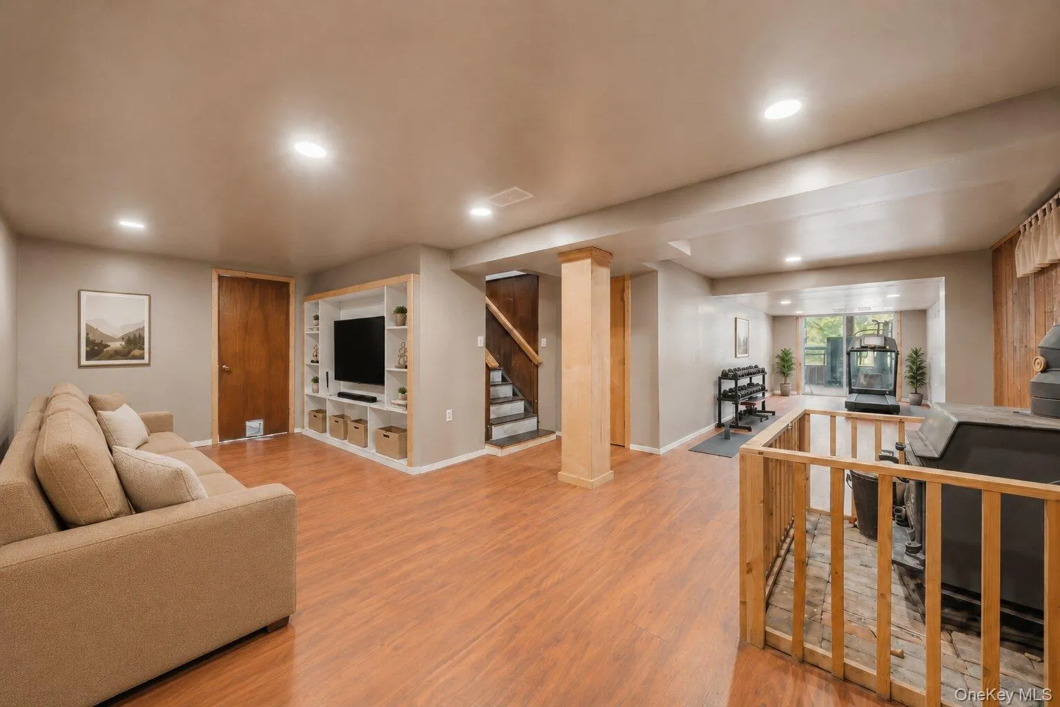 Virtually Staged. Finished lower-level space featuring wood-look flooring, recessed lighting, a brick chimney with a supplemental stove, and room for exercise equipment or hobbies. Virtually Staged. Finished lower-level space featuring wood-look flooring, recessed lighting, a brick chimney with a supplemental stove, and room for exercise equipment or hobbies.