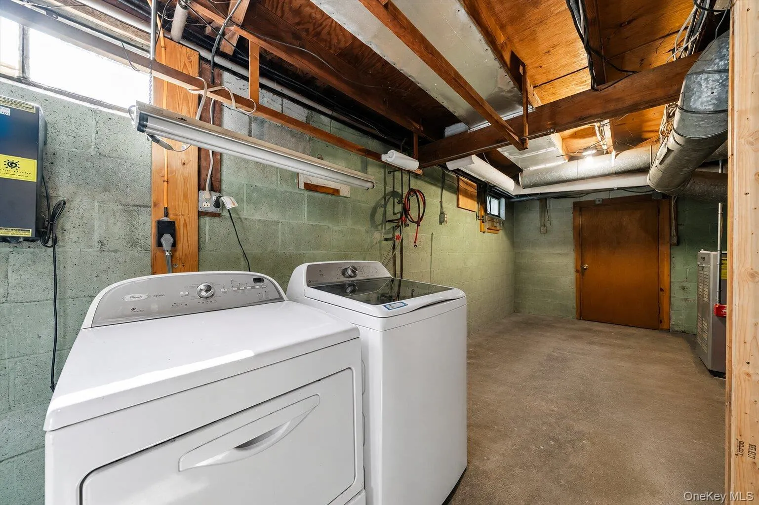 Clean lower-level utility space with laundry connections, heating equipment, storage potential, and access to the staircase. Clean lower-level utility space with laundry connections, heating equipment, storage potential, and access to the staircase.