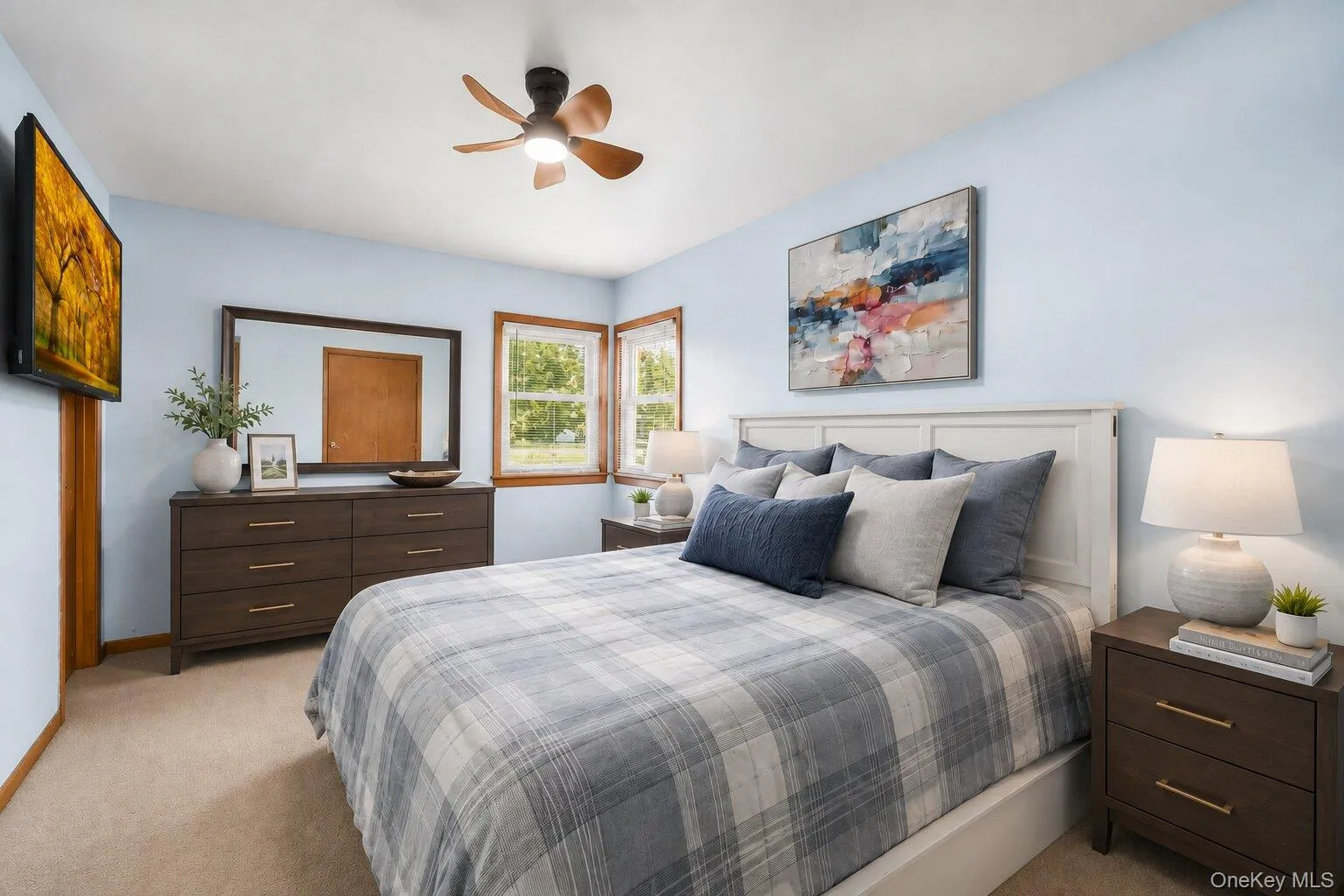 Virtually Staged Primary Bedroom: Comfortable primary bedroom with soft carpeting, generous closet space, a ceiling fan, and room for a complete bedroom set. Virtually Staged Primary Bedroom: Comfortable primary bedroom with soft carpeting, generous closet space, a ceiling fan, and room for a complete bedroom set.