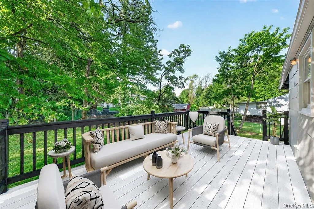 Virtually Staged. Step outside to the deck, a great space for morning coffee, outdoor dining, grilling, or simply relaxing while enjoying the backyard setting. Virtually Staged. Step outside to the deck, a great space for morning coffee, outdoor dining, grilling, or simply relaxing while enjoying the backyard setting.