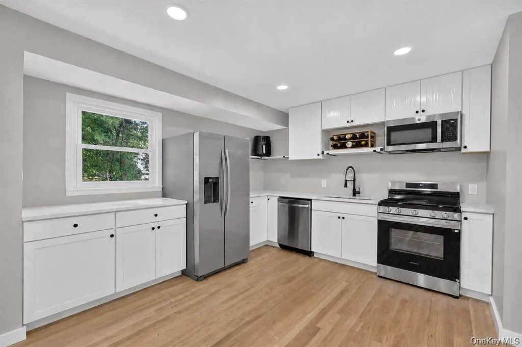 Renovated kitchen features a fresh, updated look with new appliances, making meal prep and everyday cooking both stylish and functional. Renovated kitchen features a fresh, updated look with new appliances, making meal prep and everyday cooking both stylish and functional.