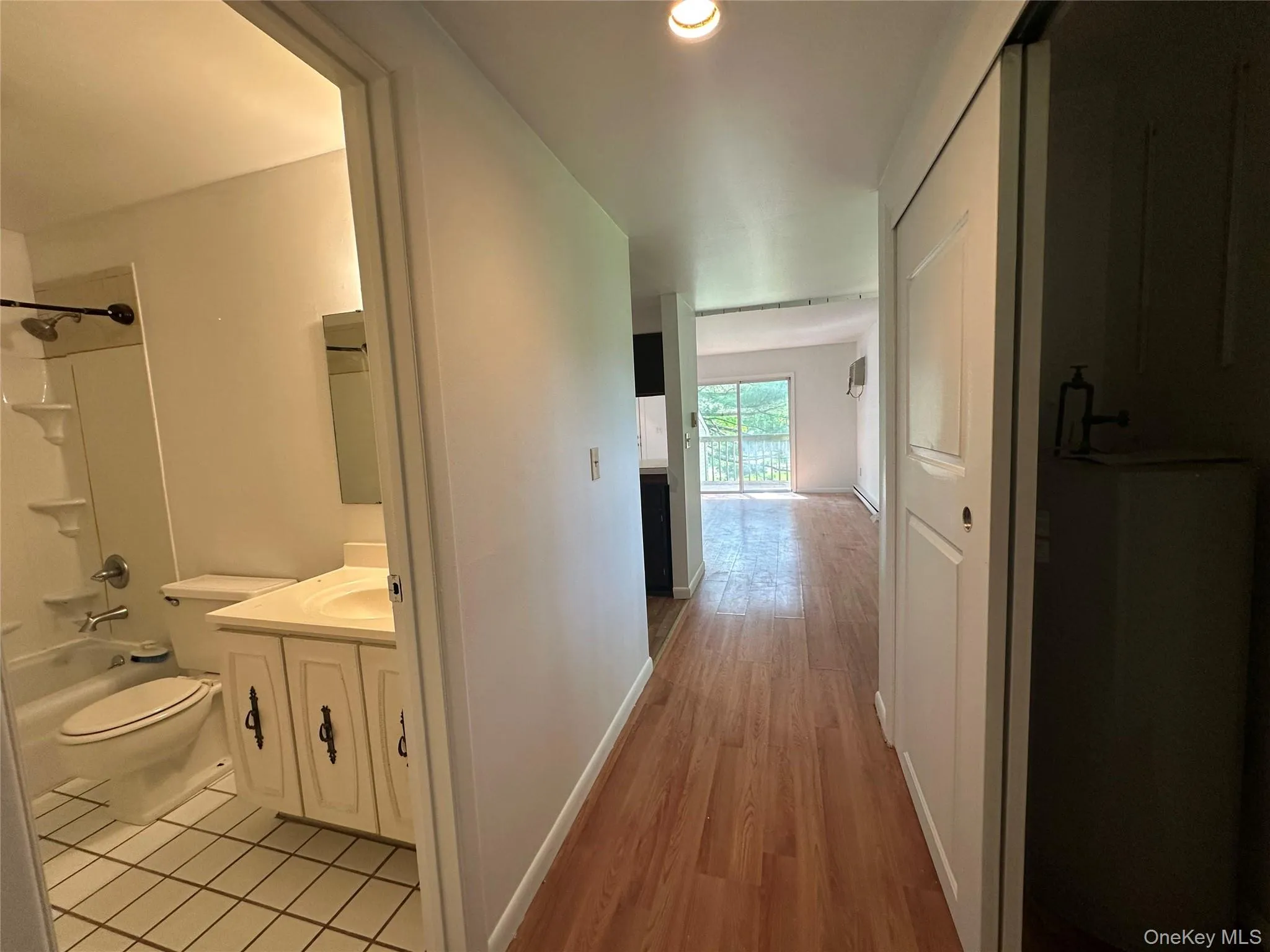Hallway featuring light wood-style floors and baseboards Hallway featuring light wood-style floors and baseboards