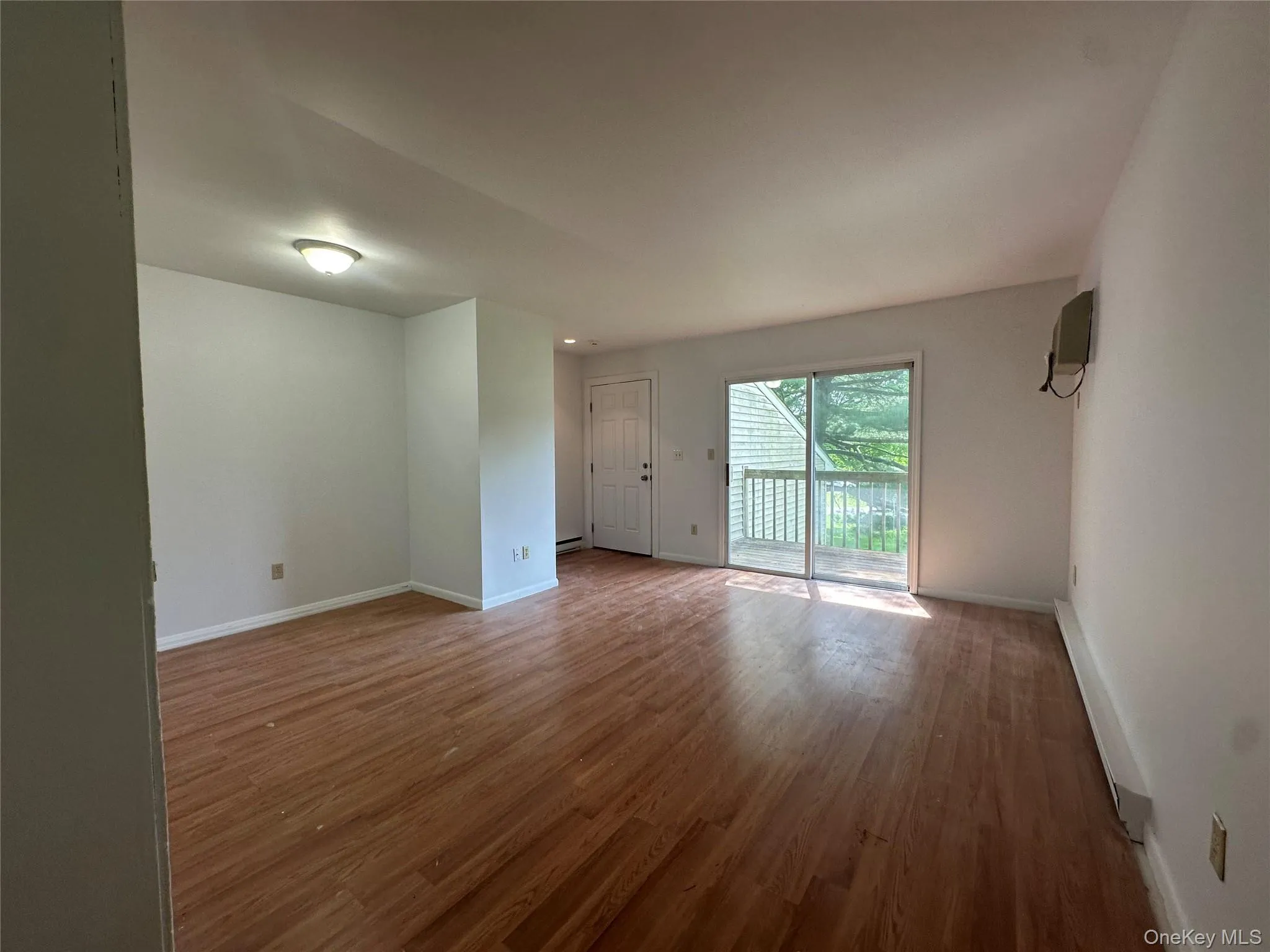 Empty room featuring baseboards and wood finished floors Empty room featuring baseboards and wood finished floors