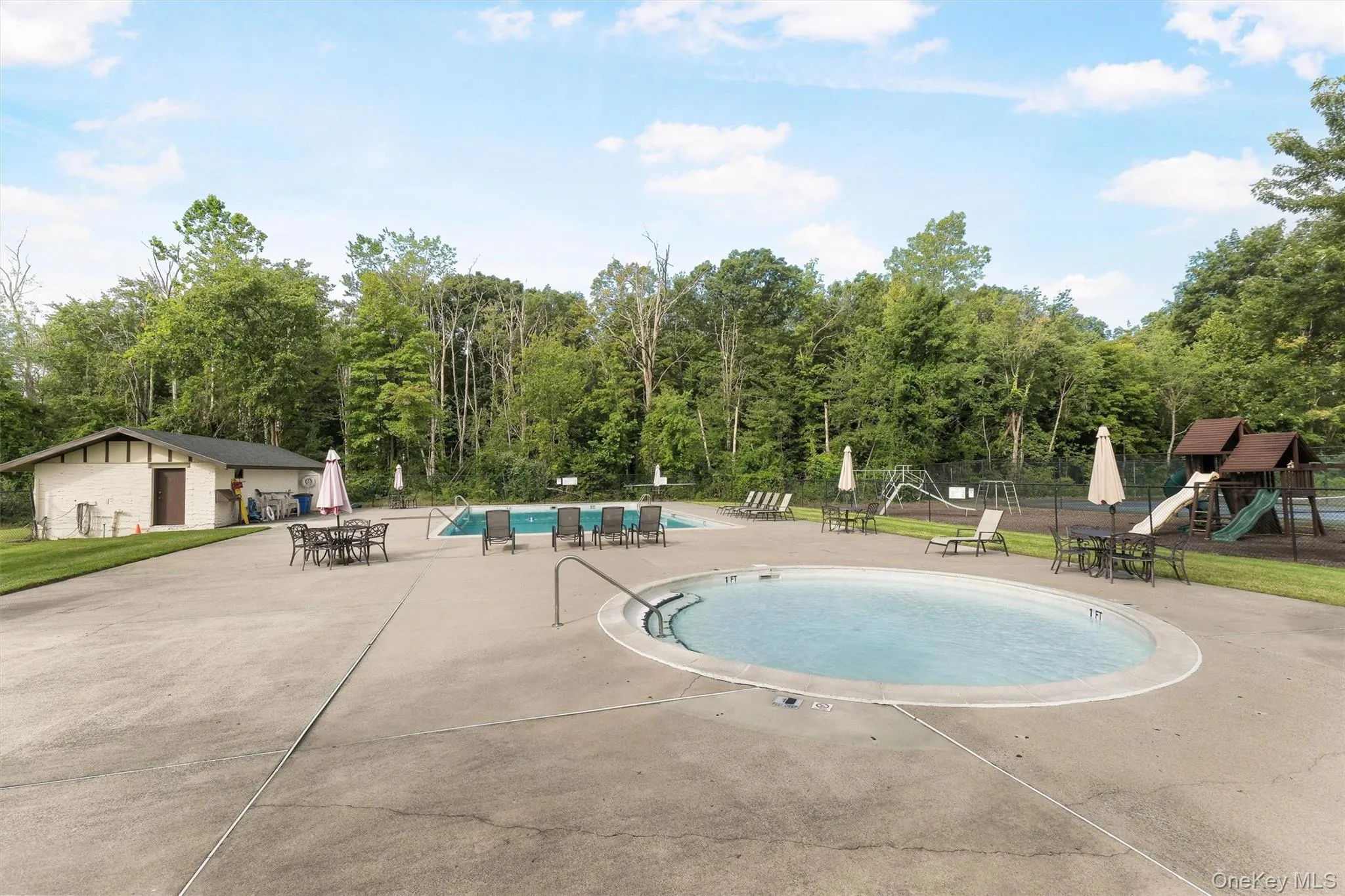 Community Swimming Pools – Enjoy a spacious pool area featuring a main swimming pool, a separate shallow pool, lounge seating, tables, and nearby playground facilities. Community Swimming Pools – Enjoy a spacious pool area featuring a main swimming pool, a separate shallow pool, lounge seating, tables, and nearby playground facilities.