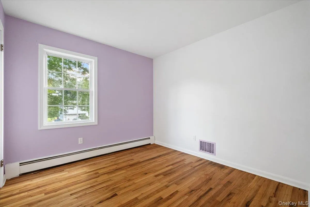 Second bedroom with hardwood floors Second bedroom with hardwood floors