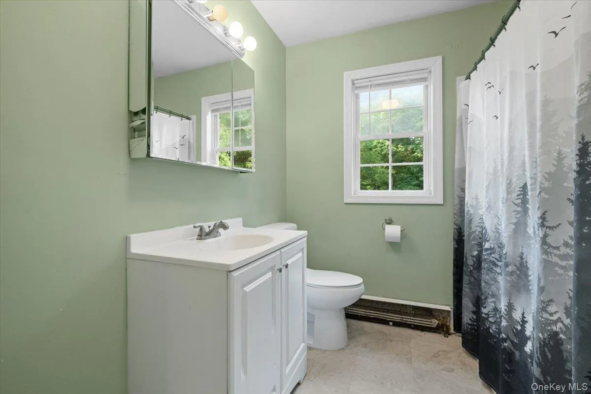 Full bathroom with a shower/tub combination. Full bathroom with a shower/tub combination.