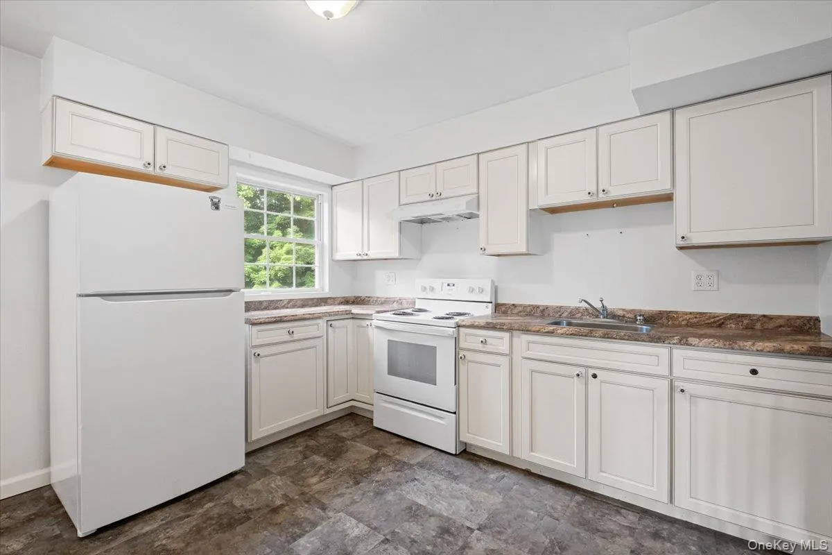 Kitchen has tons of cabinets and countertops Kitchen has tons of cabinets and countertops