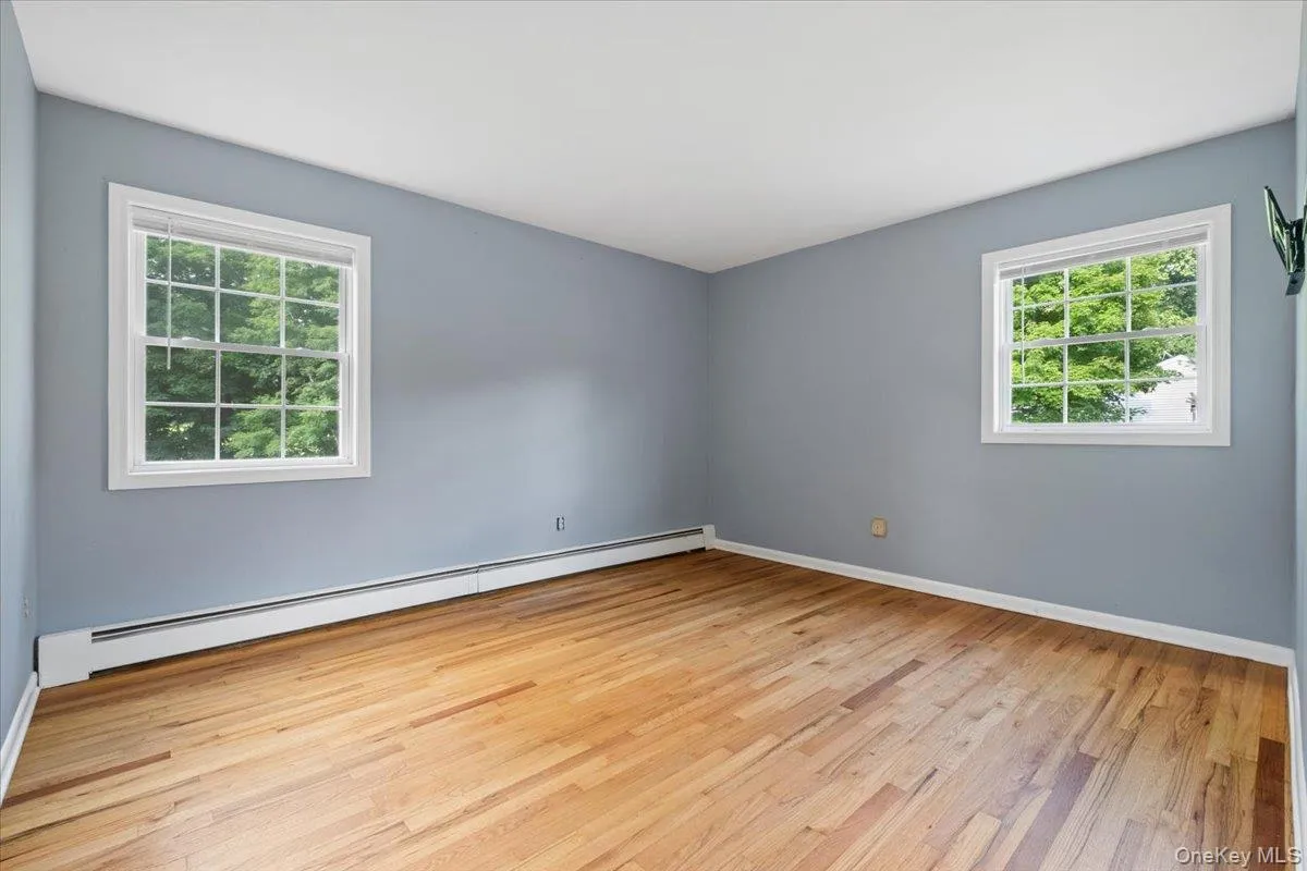 Primary bedroom with hardwood floors Primary bedroom with hardwood floors