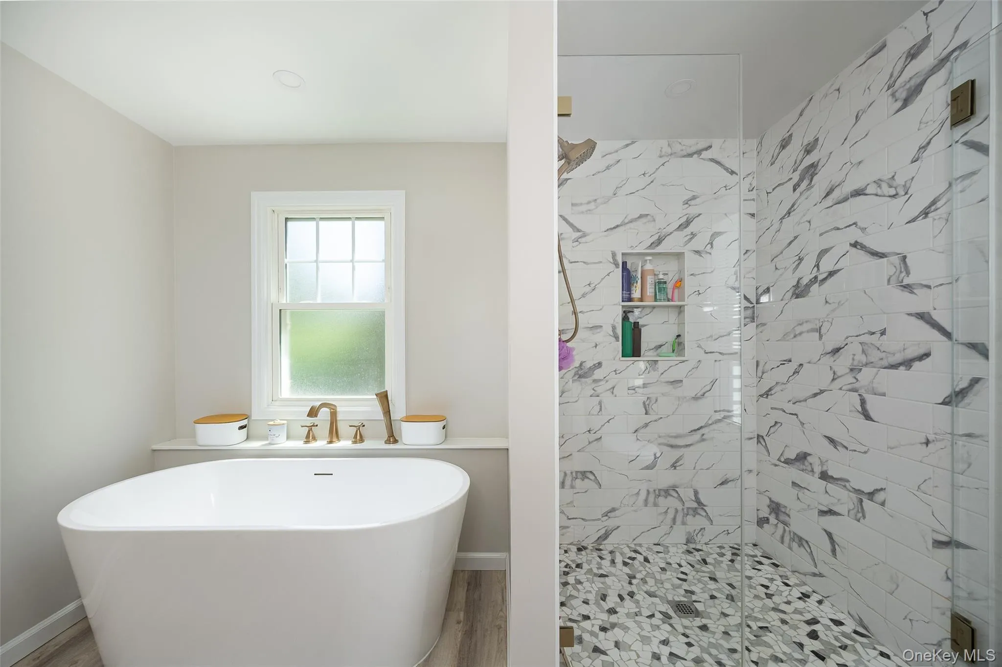 Freestanding soaking tub with brushed gold fixtures Freestanding soaking tub with brushed gold fixtures