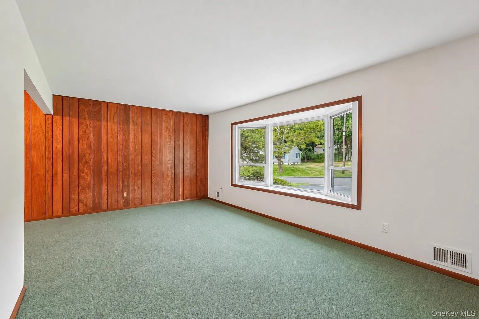 Hardwood floors exist under carpeting. Large bay window floods the living room with light Hardwood floors exist under carpeting. Large bay window floods the living room with light