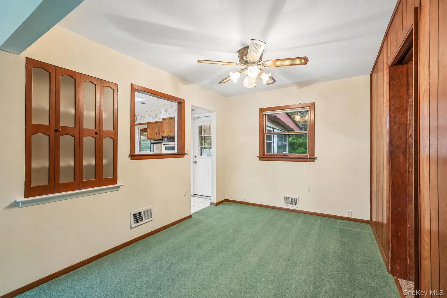 Harwood under carpeted floor, view towards kitchen on left and family room/bedroom on right Harwood under carpeted floor, view towards kitchen on left and family room/bedroom on right