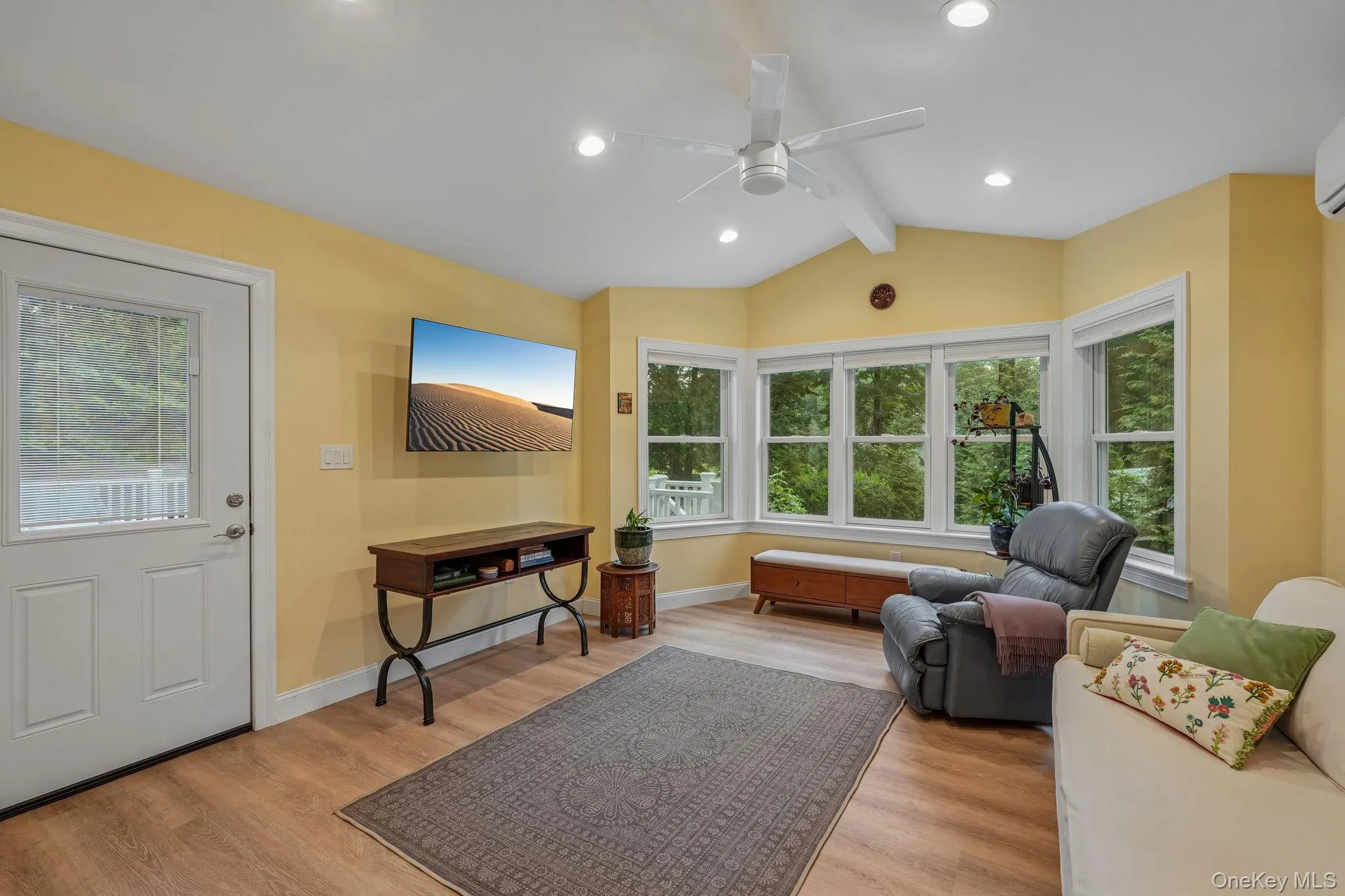 Enclosed porch with vaulted, beamed ceiling and its own heating and cooling system. Access to deck Enclosed porch with vaulted, beamed ceiling and its own heating and cooling system. Access to deck
