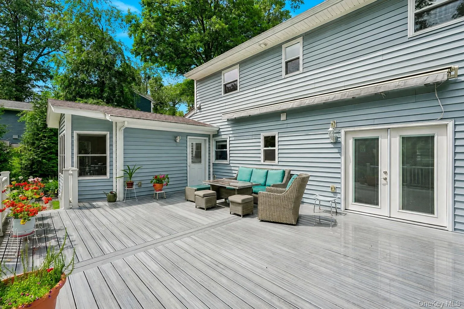 Trex deck, retractable awning, glass doors lead to living room Trex deck, retractable awning, glass doors lead to living room