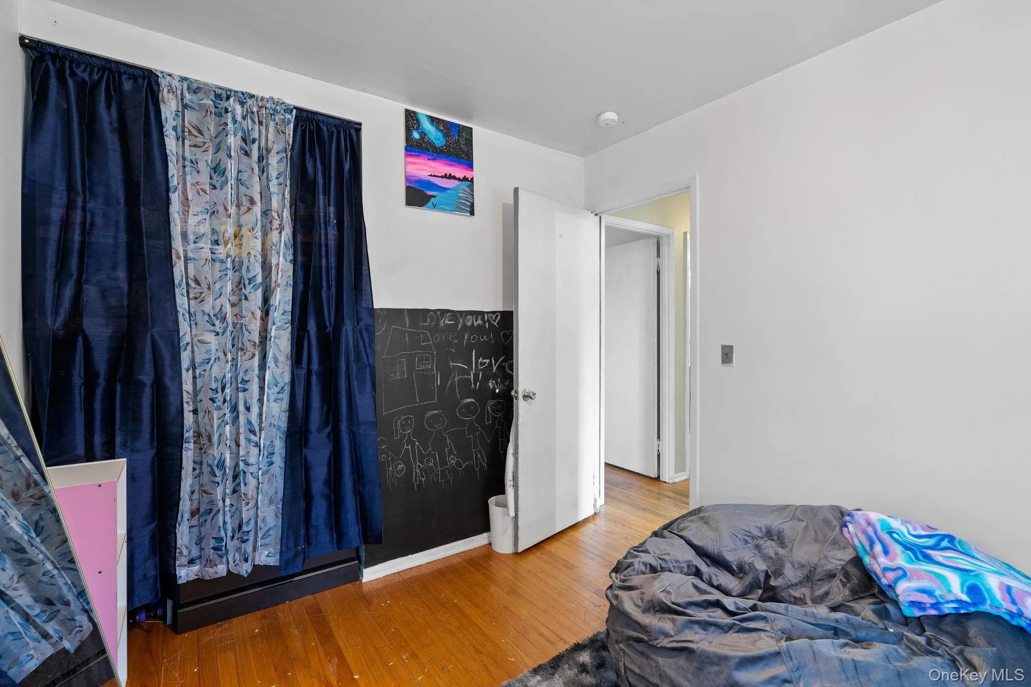 Bedroom featuring wood finished floors Bedroom featuring wood finished floors