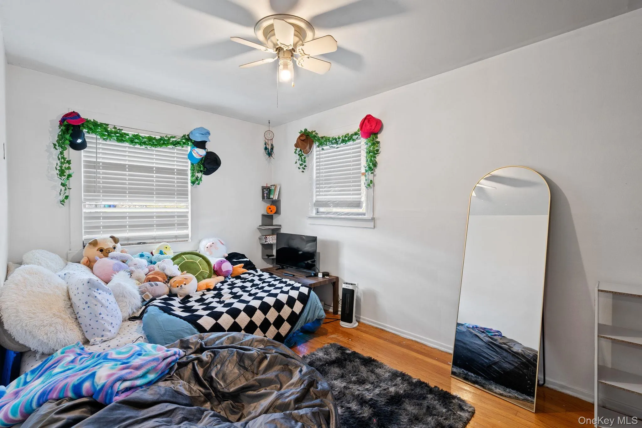 Bedroom with ceiling fan and wood finished floors Bedroom with ceiling fan and wood finished floors
