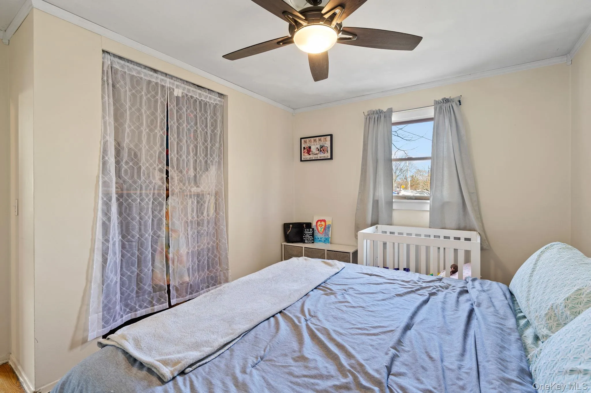 Bedroom with crown molding and ceiling fan Bedroom with crown molding and ceiling fan