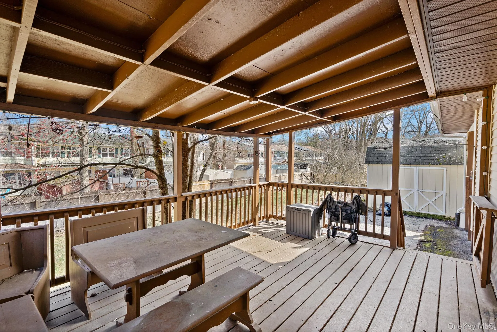 Wooden deck with an outdoor structure and a storage shed Wooden deck with an outdoor structure and a storage shed